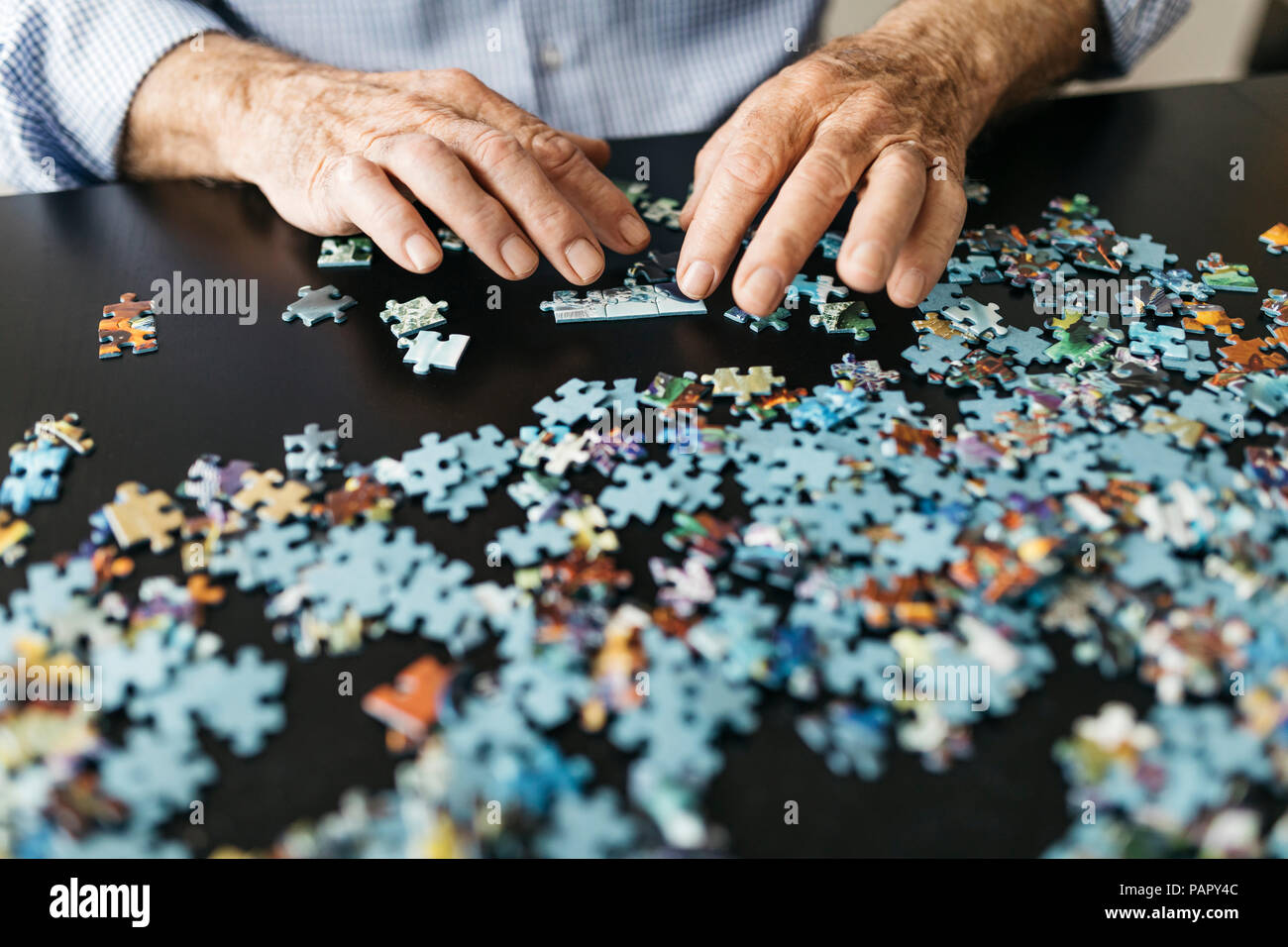 Senior man doing a jigsaw Stock Photo