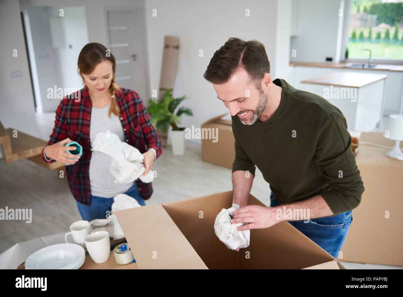 Couple moving house packing their belongings Stock Photo