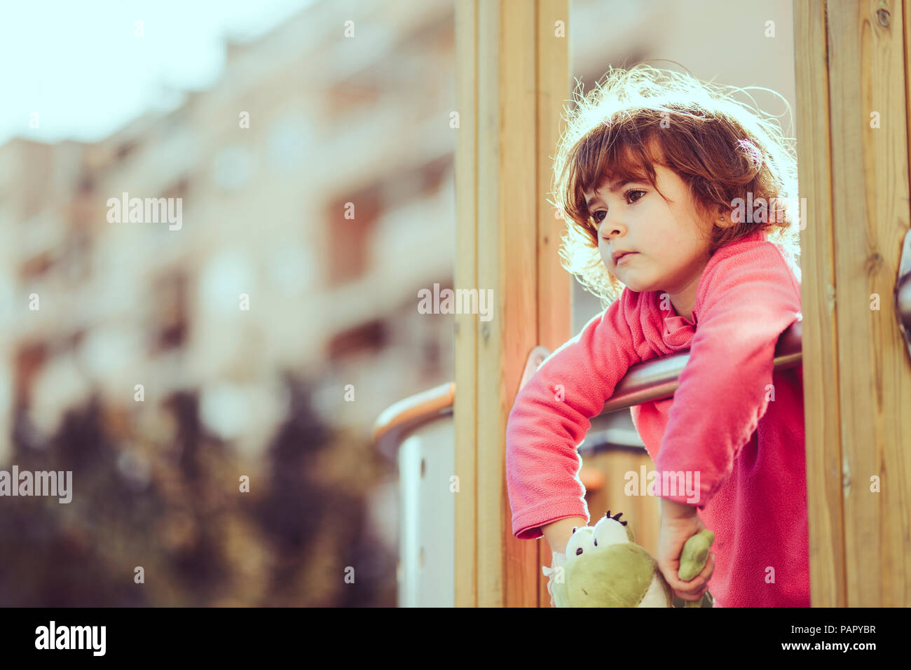 Portrait of sad little girl at playground Stock Photo