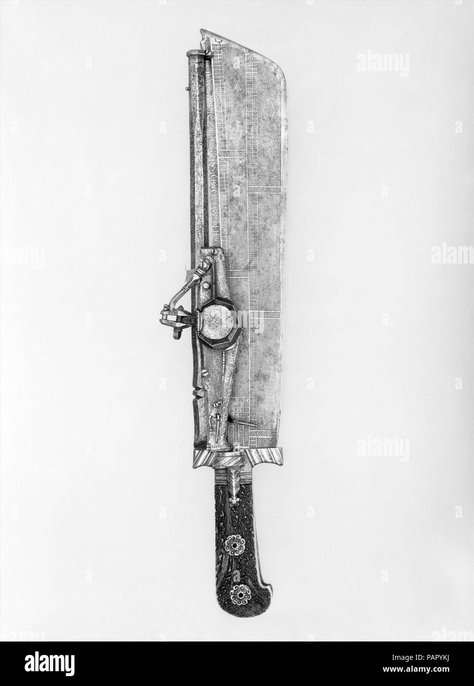 Hunting Knife Combined with Wheellock Pistol. Culture: German, Munich. Dimensions: L. 18 1/4 in. (46.4 cm); L. of barrel 12 3/8 in. (31.4 cm); L. of blade 13 1/4 in. (33.7 cm); Cal. .28 in. (7.1 mm). Etcher: Ambrosius Gemlich (German, Munich and Landshut, active ca. 1520-50). Date: blade ca. 1528-29, etched with a calendar for the years 1529-34; barrel dated 1540 or 1546.  In the sixteenth century, wheellock pistols sometimes were combined with swords, knives, axes, maces, spears, and even crossbows, which could be used in the event the pistol misfired. Usually clumsy and impractical, combined Stock Photo