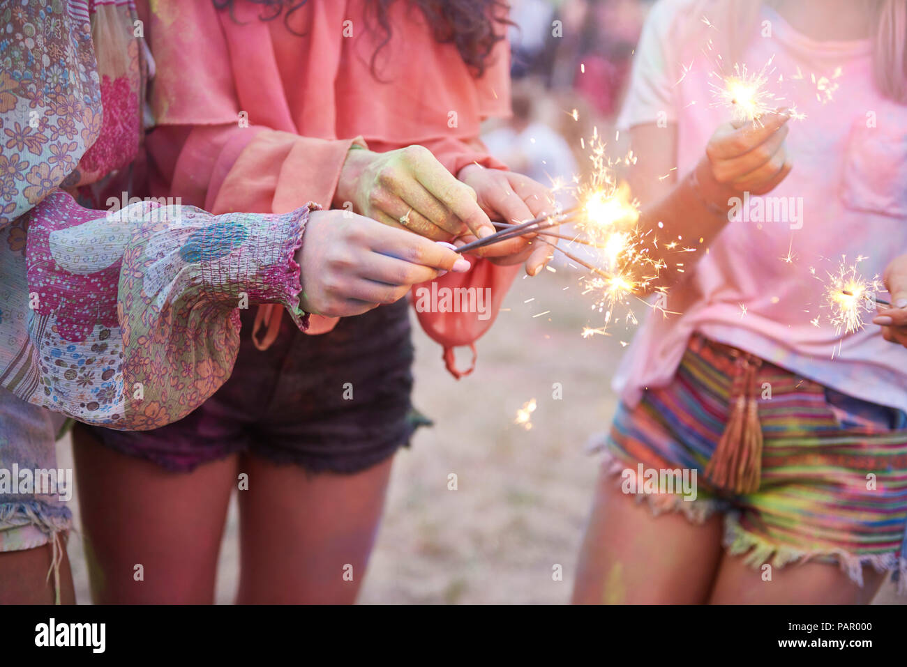 Women having fun with sparklers at music festival Stock Photo