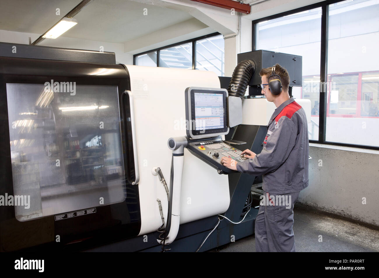 Stonemason working with CNC machine in his workshop Stock Photo