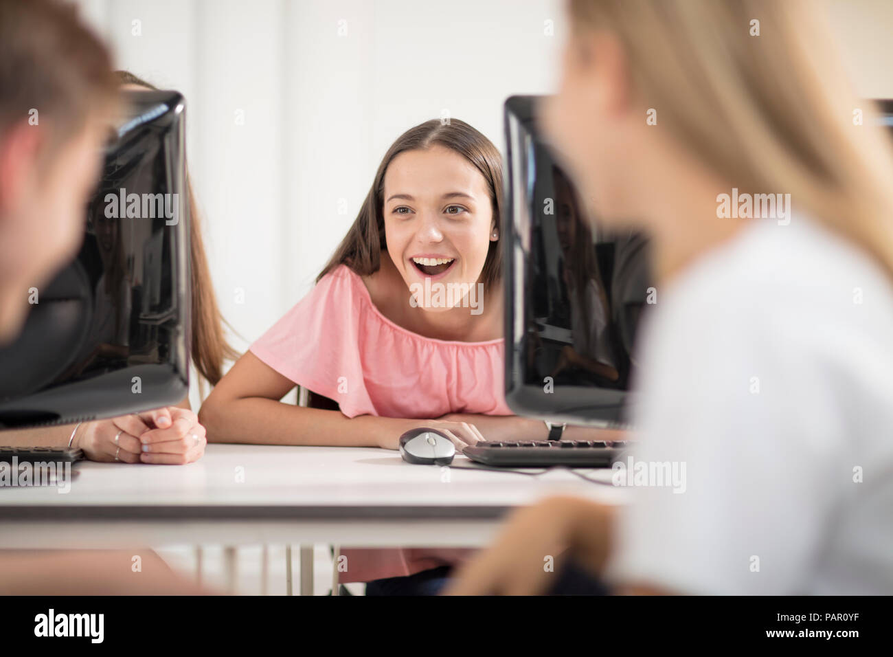 Students talking in computer class Stock Photo