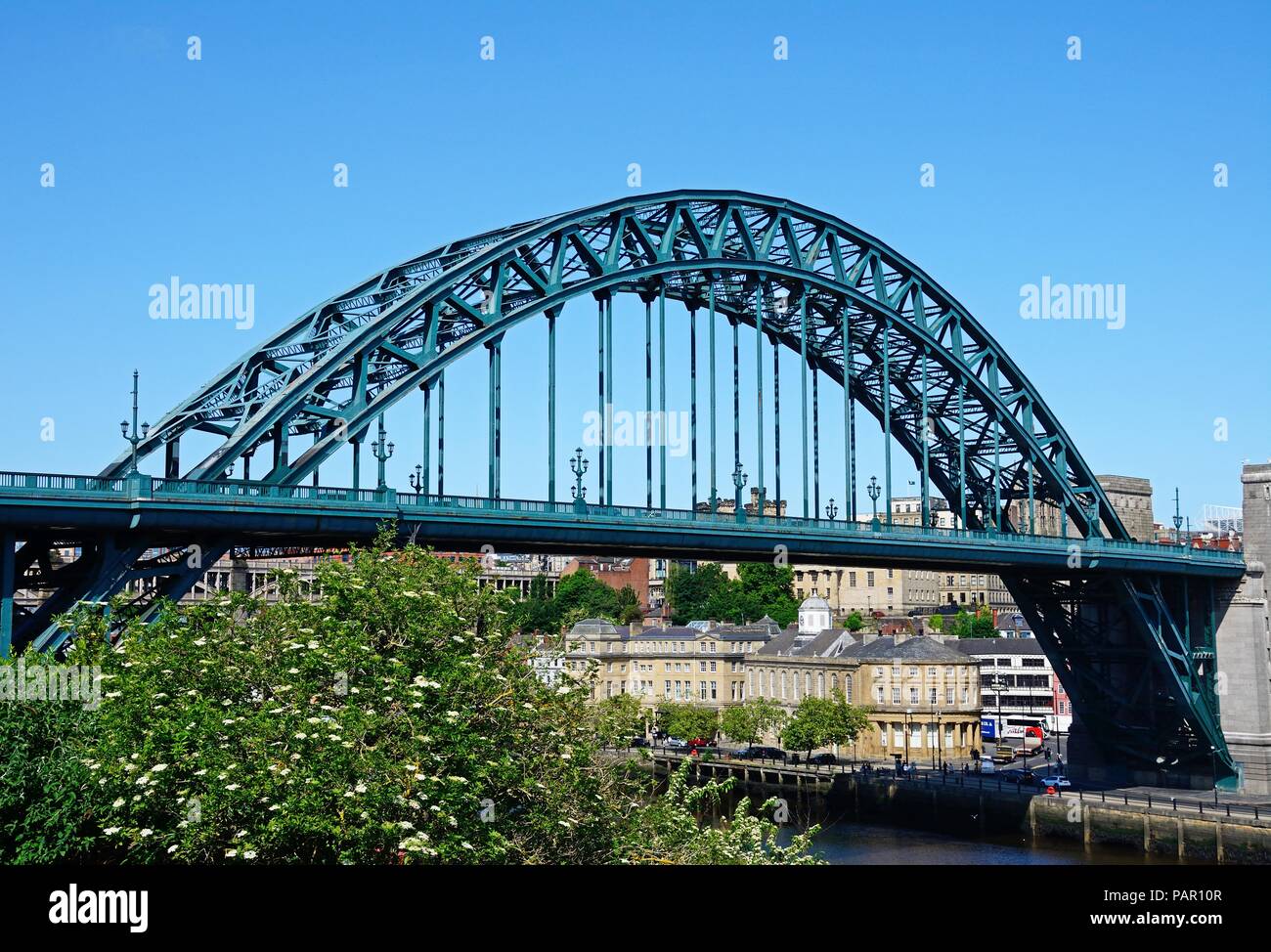 View of the Tyne Bridge across the River Tyne with city buildings to the rear seen from the Gateshead side of the river, Newcastle upon Tyne, Tyne and Stock Photo
