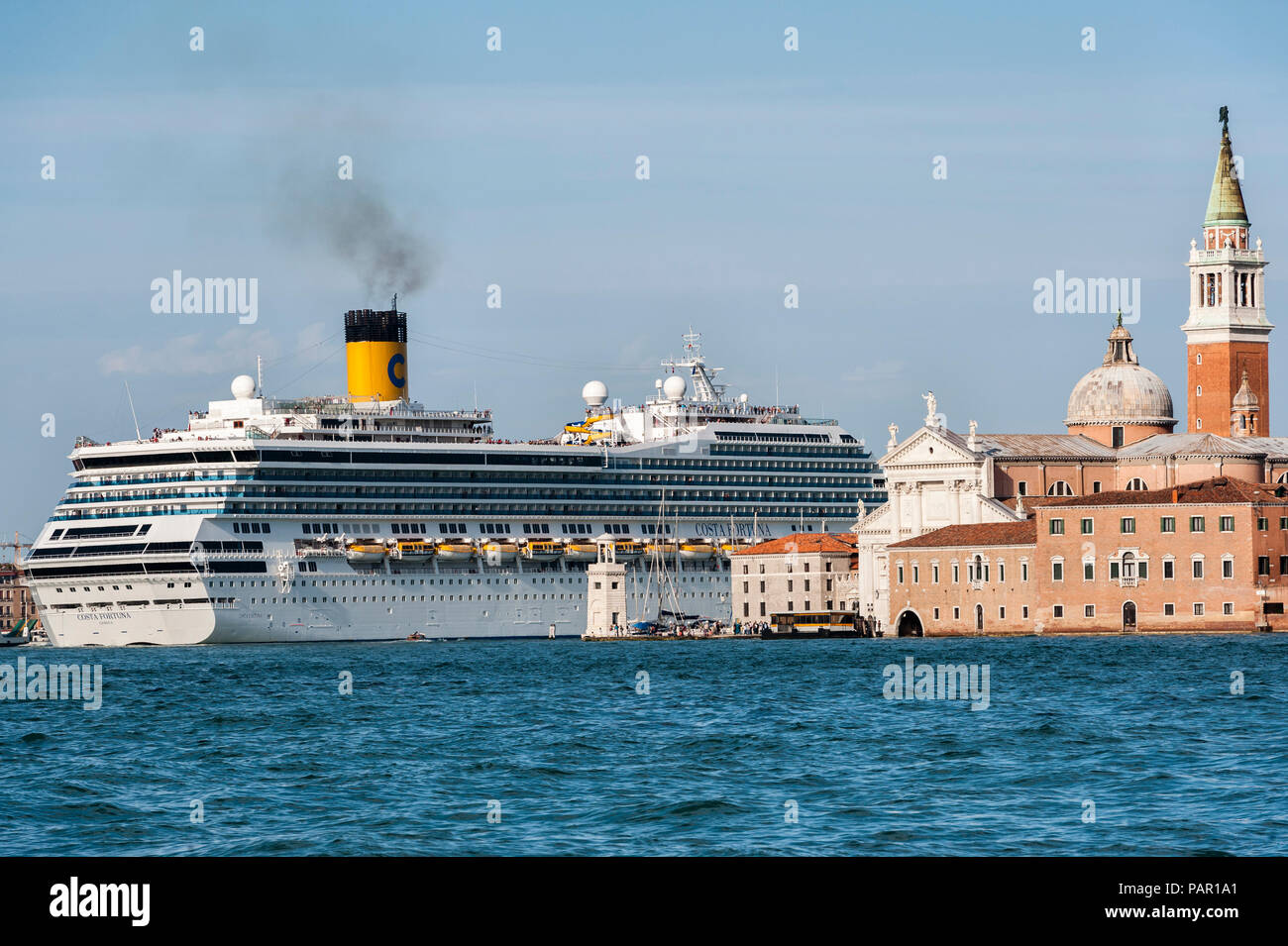 The huge cruise ship Costa Fortuna (owned by the cruise company Carnival Corporation) in Venice, Italy, passing the church of San Giorgio Maggiore Stock Photo