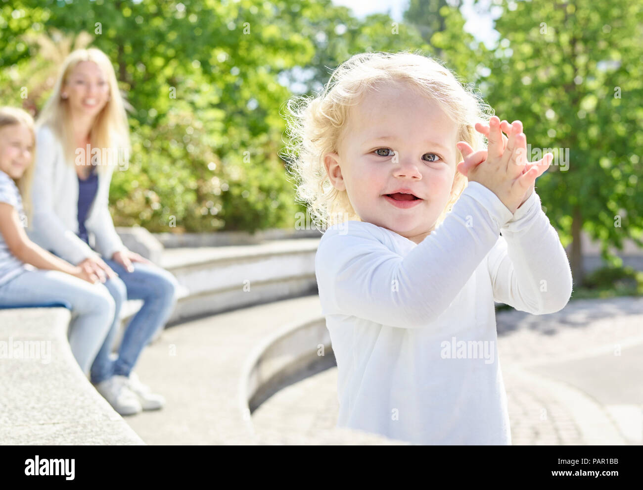 Portrait of smiling toddler with  hands clasped Stock Photo