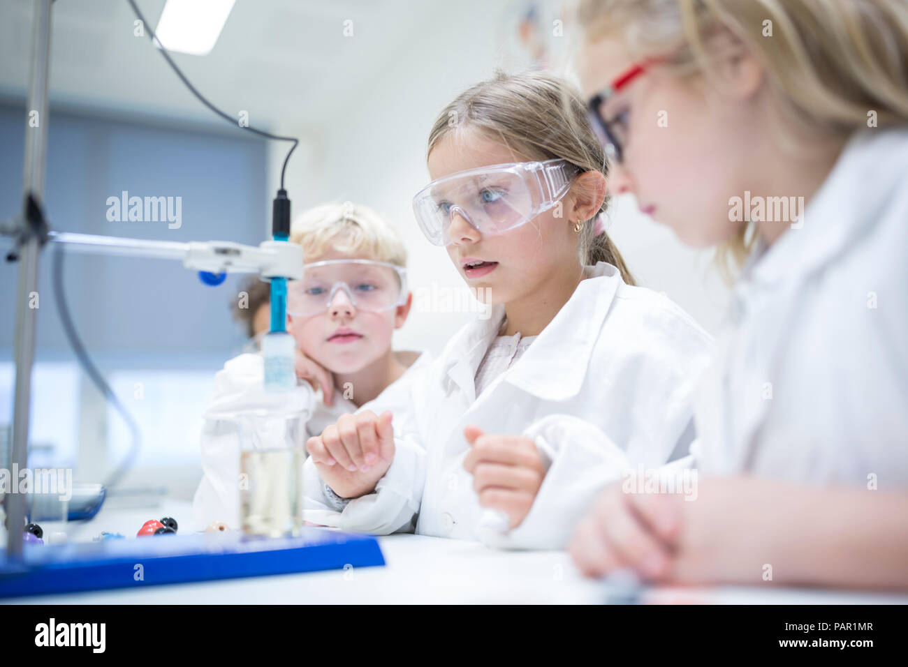 Pupils experimenting in science class Stock Photo