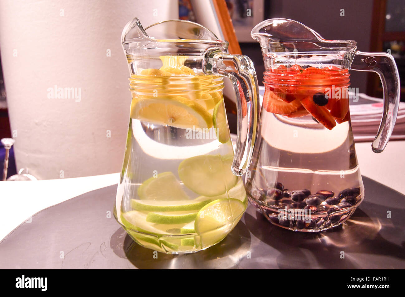 https://c8.alamy.com/comp/PAR1RH/two-jugs-of-fresh-fruit-in-water-creating-home-made-helthy-fruit-juice-PAR1RH.jpg