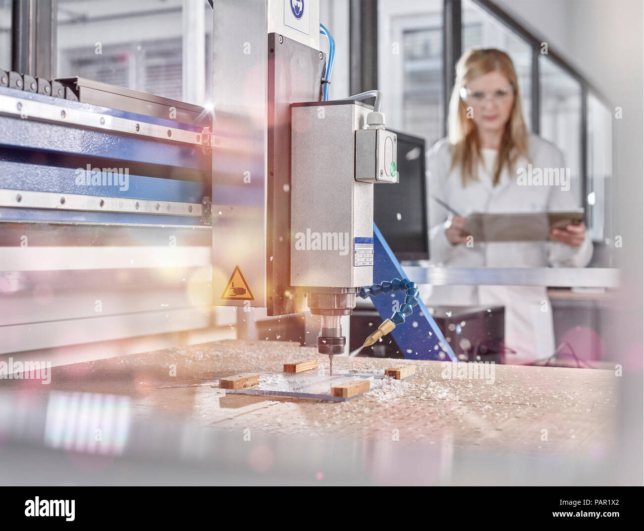 Female technician controlling CNC milling machine Stock Photo