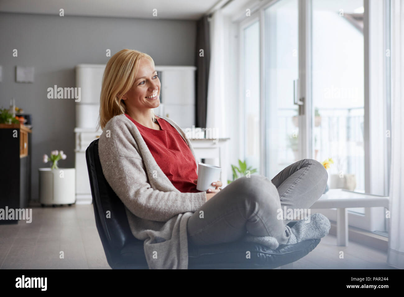 Happy woman relaxing at home Stock Photo