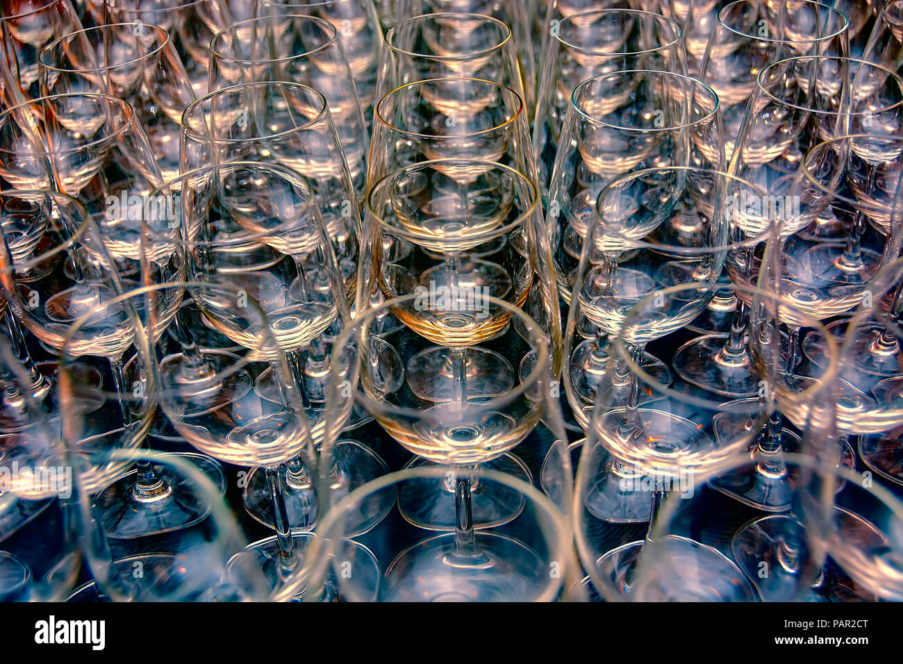 Rows and rows of empty water goblets in restaurant Stock Photo