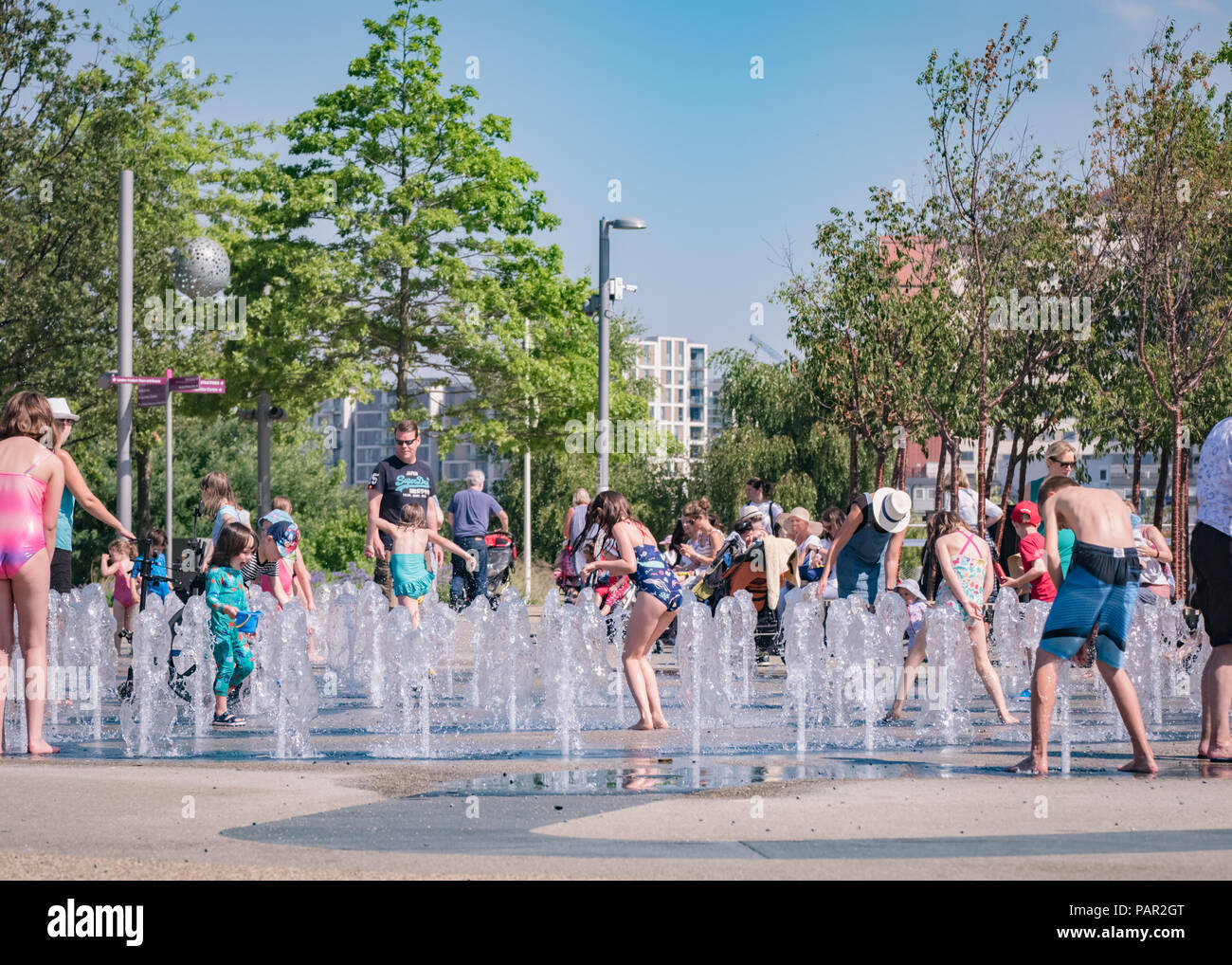 Children playing in the splash fountains at Queen Elizabeth Olympic Park, Stratford, East London, during the summer heatwave of 2018 Stock Photo