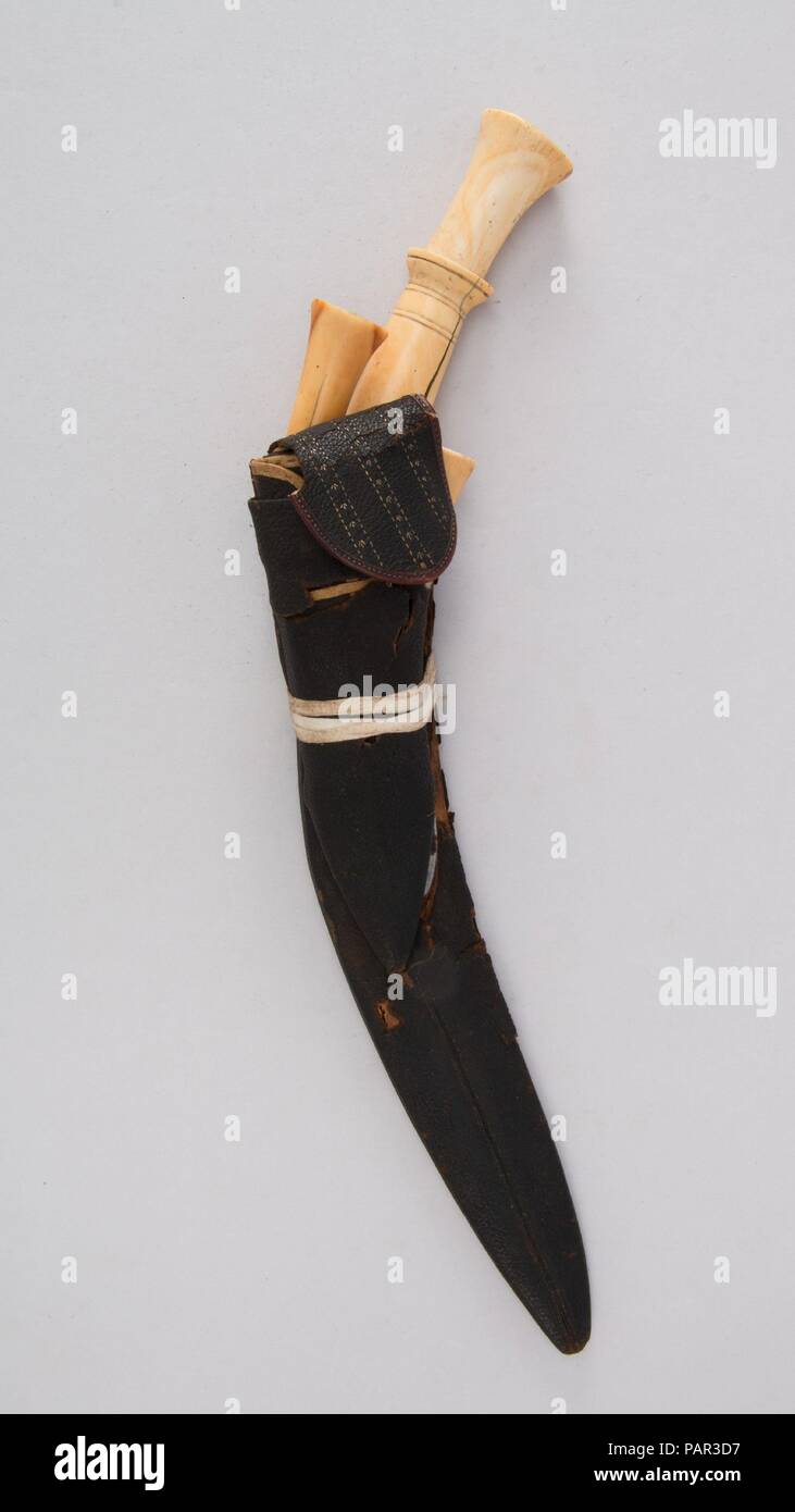 Knife (Kukri) with Sheath, Two Small Knives and Pouch. Culture: Indian or Nepalese, Gurkha. Dimensions: Knife (a); H. with sheath 16 13/16 in. (42.7 cm); H. without sheath 16 13/16 in. (42.7 cm); W. 1 1/2 in. (3.8 cm); Wt. 14.2 oz. (402.6 g); sheath (b); Wt. 3.3 oz. (93.6 g); small knife (c); H. 6 5/16 in. (41.4 cm); W. 1 1/16 in. (2.7 cm); Wt. 2.3 oz. (65.2 g); small knife (d); H. 6 13/16 in. (17.3 cm); W. 1 3/16 in. (3 cm); Wt. 2 oz. (56.7 g). Date: 19th century. Museum: Metropolitan Museum of Art, New York, USA. Stock Photo