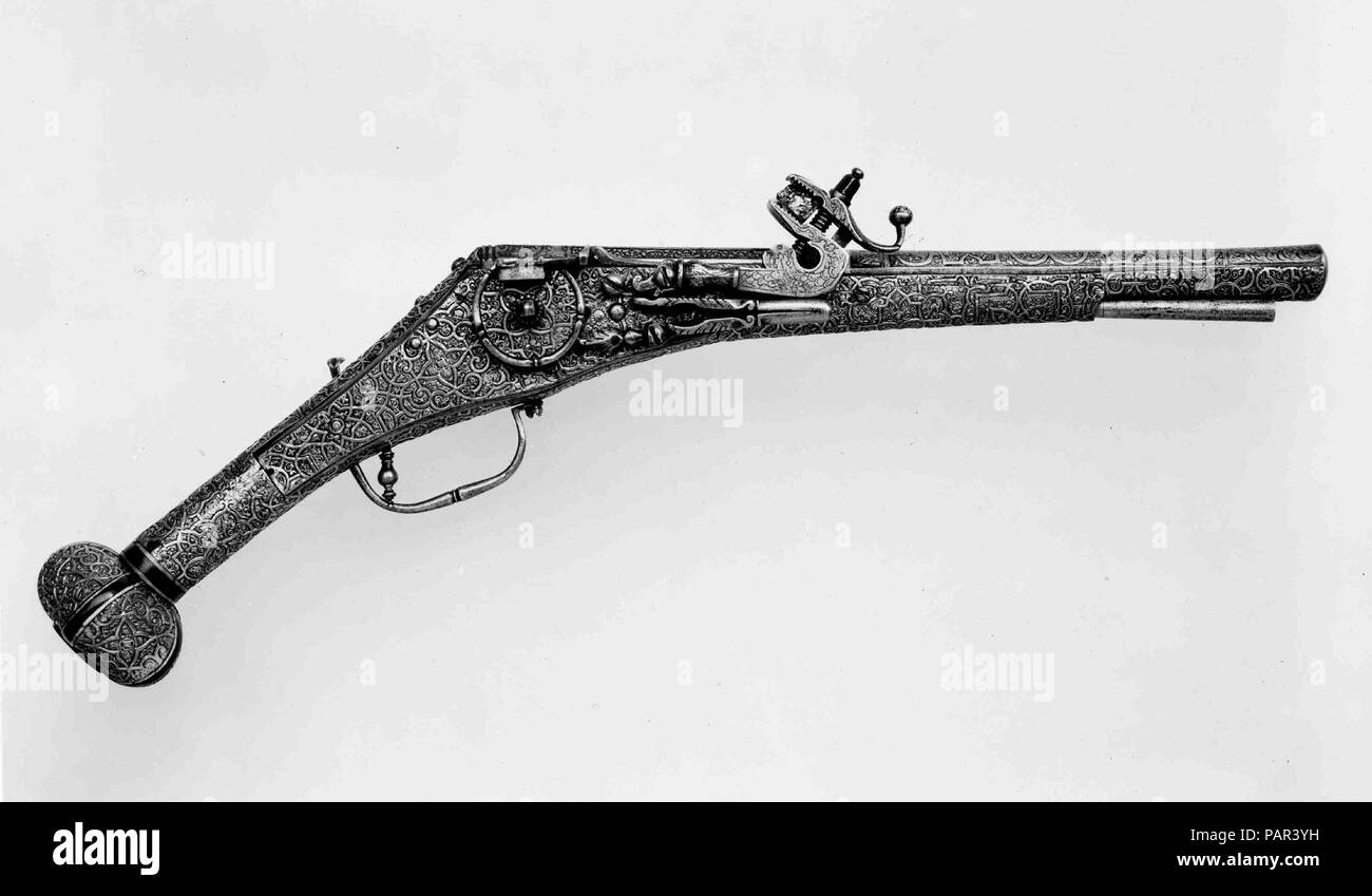 Wheellock Pistol. Culture: German, Augsburg. Dimensions: L. 20 3/8 in. (51.7 cm); L. of barrel 13 7/16 in. (34.1 cm); Cal. .492 in. (12.5 mm); Wt. 4 lb. 4 oz. (1928 g). Date: ca. 1560-70.  The sheathing of the stock in plaques of gilt copper with raised strapwork ornament is highly unusal but recalls clock cases, powder flasks, and other decorative metal objects made in Augsburg. Museum: Metropolitan Museum of Art, New York, USA. Stock Photo