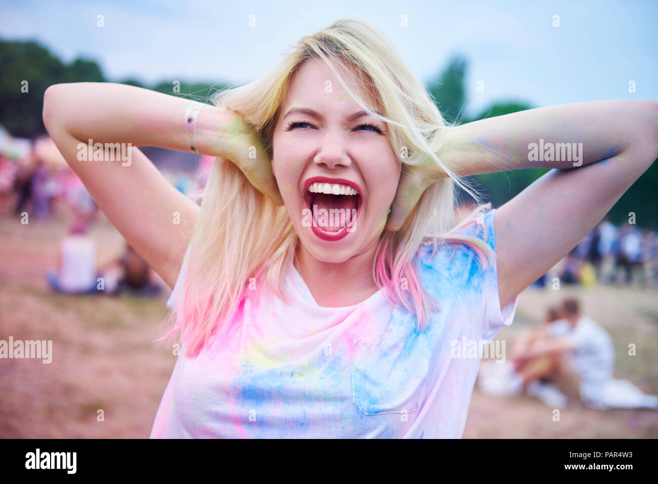 Hipster woman singing during music festival Stock Photo