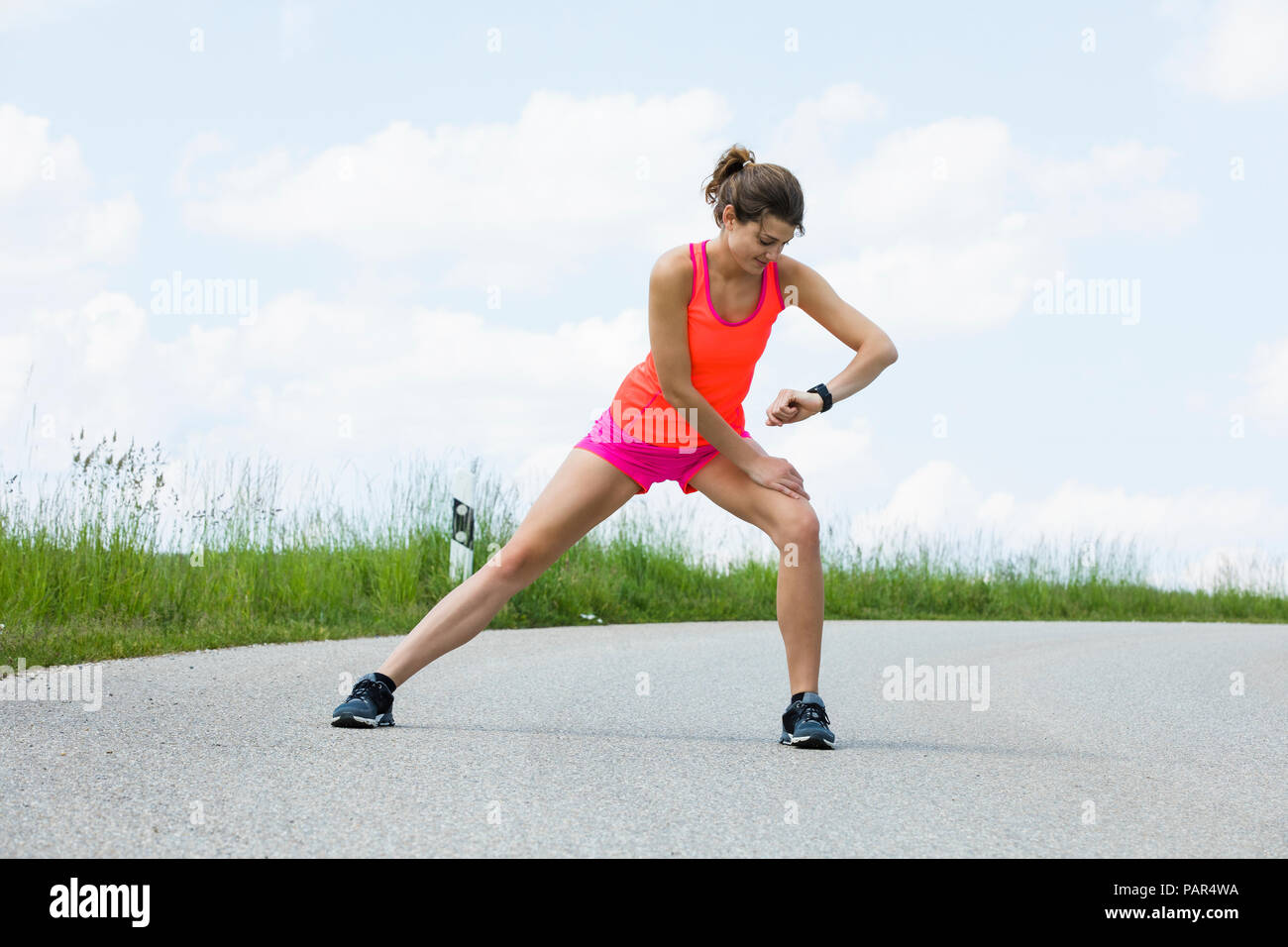 Jogging woman doing stretching exercises on street Stock Photo Alamy