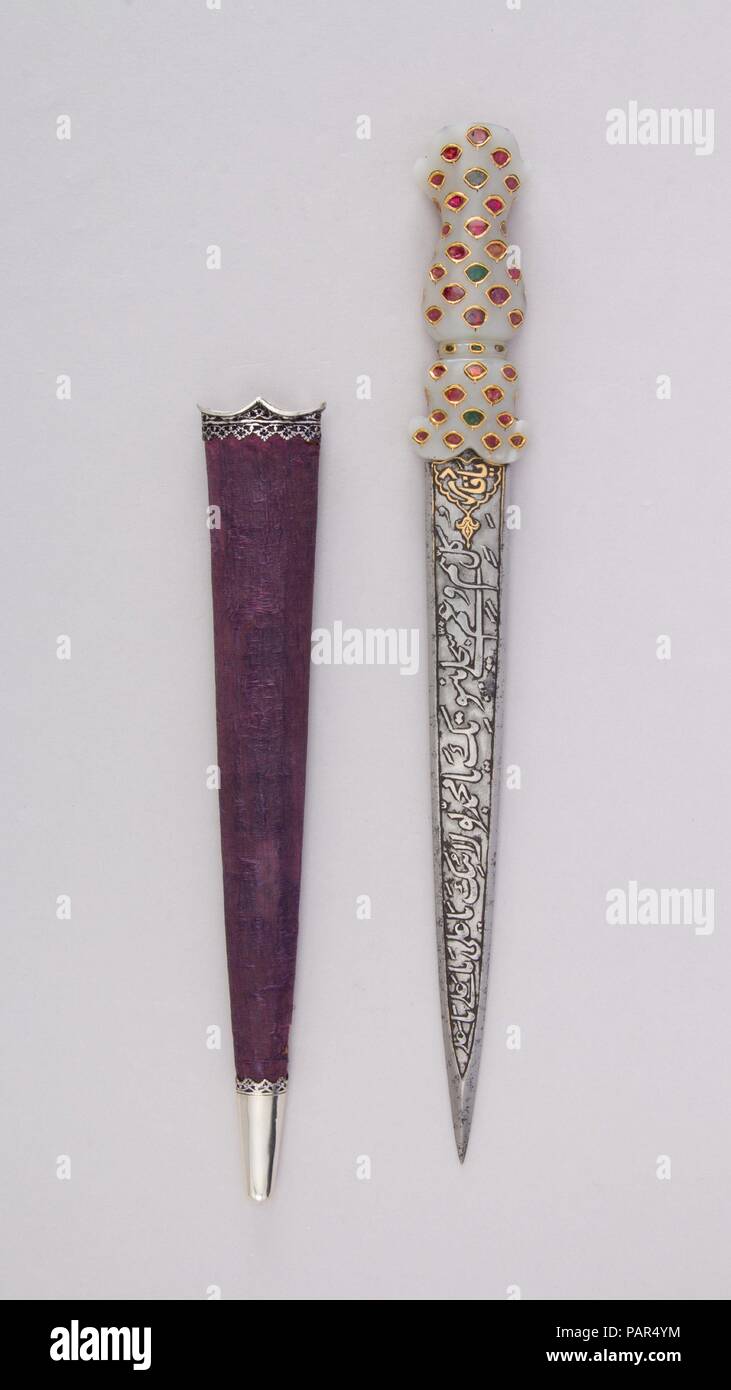 Dagger with Sheath. Culture: Indian, probably Deccan. Dimensions: L. with sheath 15 5/16 in. (38.9 cm); L. without sheath 14 1/8 in. (35.9 cm); L. of blade 9 1/2 in. (24.1 cm); W. 1 11/16 in. (4.3 cm); Wt. 8.7 oz. (246.6 g); Wt. of sheath 1.4 oz. (39.7 g). Date: 18th-19th century.  Like their martial counterparts, ceremonial daggers and swords were also often decorated with talismanic motifs and inscriptions. The blade of this dagger bears Arabic inscriptions praising Allah, 'Ali, and the Prophet Muhammad. One side features verses from the popular prayer <i>Nad-i 'Ali</i>. The inclusion of rub Stock Photo