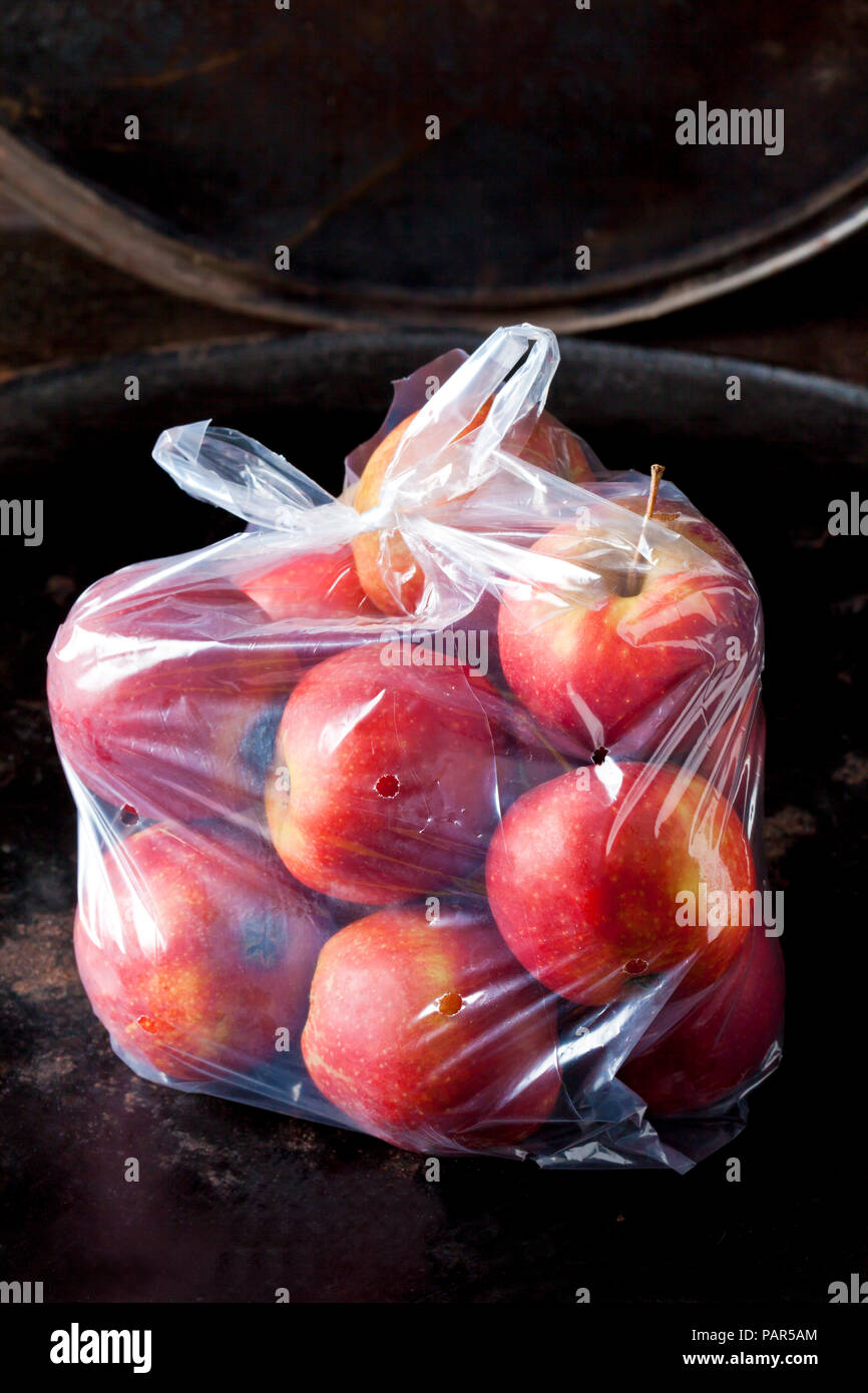 Plastic bag of red apples Stock Photo