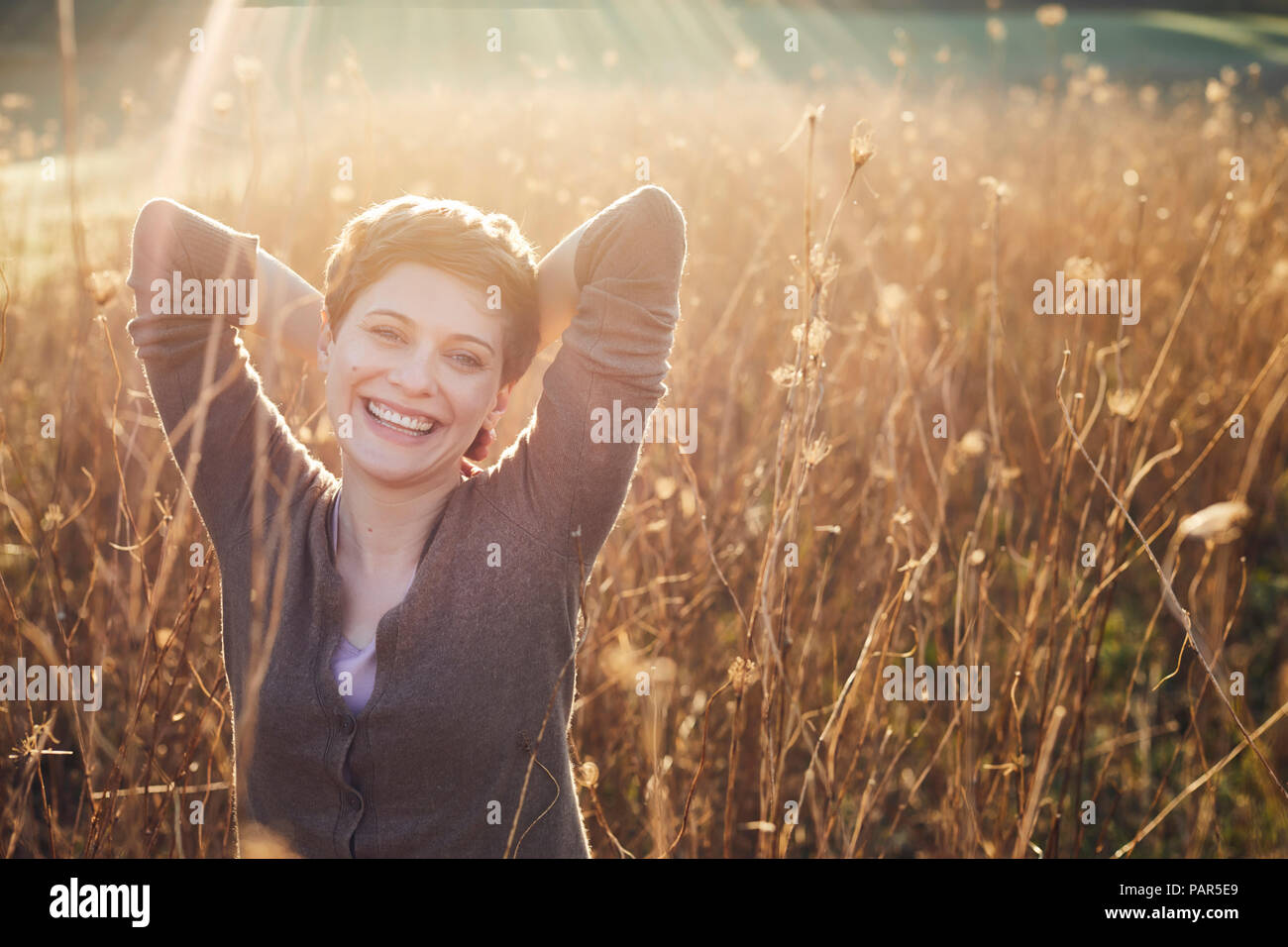Portrait of laughing woman relaxing in nature Stock Photo