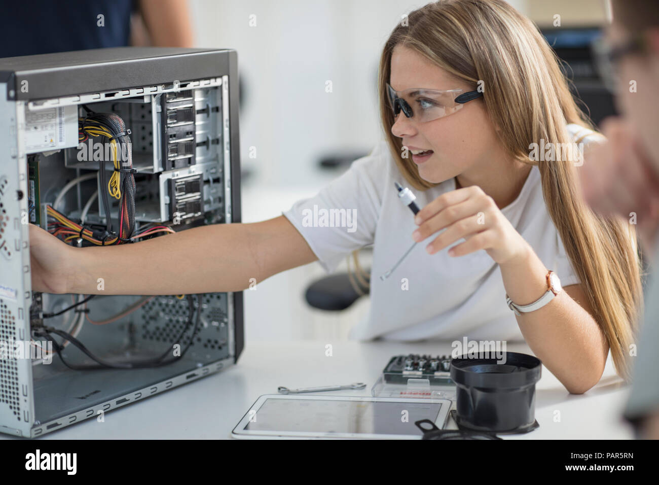 Students assembling computer in class Stock Photo