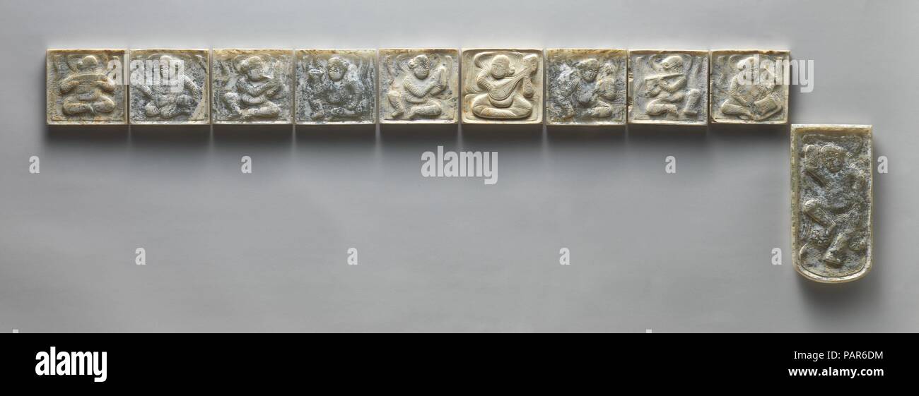 Set of Ten Belt Plaques. Culture: China. Dimensions: Each square piece: 2 1/4 x 2 1/4 in. (5.7 x 5.7 cm); end piece: 4 3/8 x 2 1/4 in. (11.1 x 5.7 cm). Date: 7th-early 8th century.  Jade from Khotan in the Tarim basin was plentiful during the Tang dynasty. It was fashioned into ornaments such as women's comb tops and decorative plaques for belts worn by senior officials. The jade plaques in this set are carved in relief with images of a dancer and musicians from central Asia, most likely Kizil. Museum: Metropolitan Museum of Art, New York, USA. Stock Photo