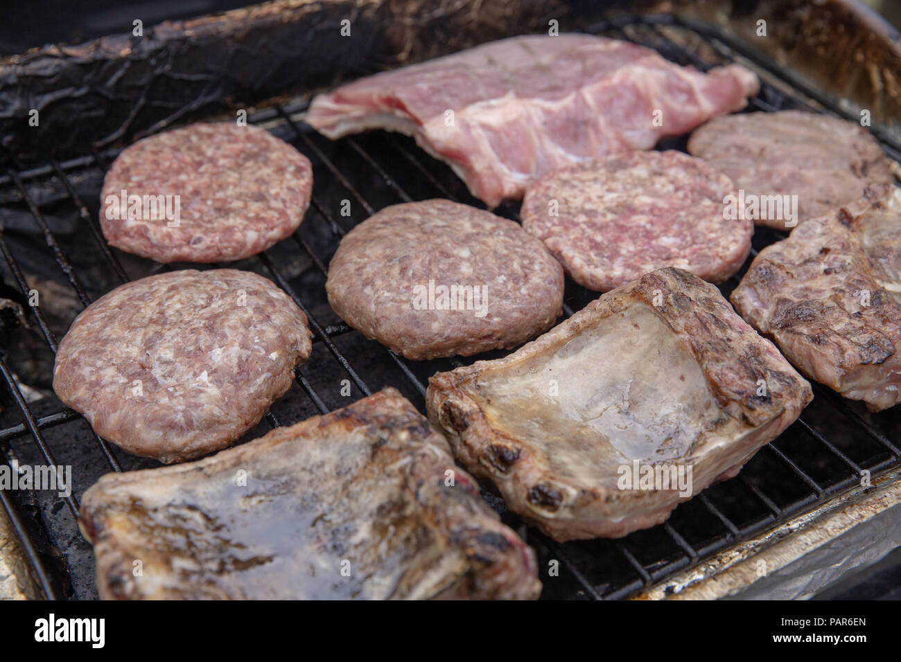Meats being cooked on a gas grill Stock Photo Alamy