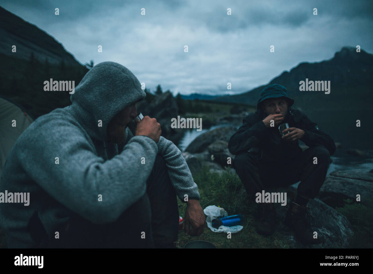 Norway, Lofoten, Moskensoy, Young men having breakfast at Selfjord Stock Photo