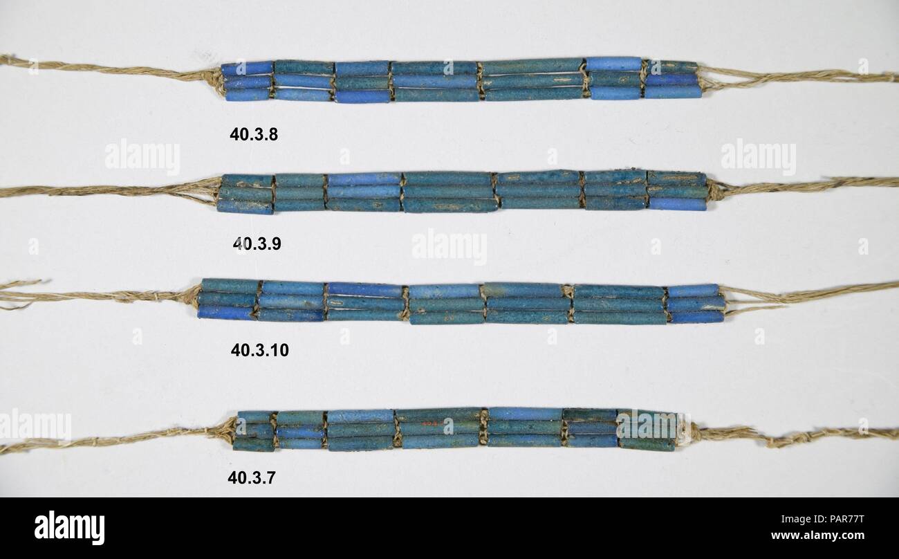 Anklet of Wah. Dimensions: Overall length 50 cm (19 11/16 in); beads only 12.8 cm (5 1/16 in). Dynasty: Dynasty 12. Reign: reign of Amenemhat I, early. Date: ca. 1981-1975 B.C..  Wah's broad collar (40.3.2), anklets and bracelets (40.3.3-40.3.10) were made as funerary ornaments for the burial and were found in the layers of linen wrapping that were closest to the body; the collar had been tied around the neck, and the bracelets and anklets had been laid over the lower arms and legs.  They are all made of a ceramic material called Egyptian faience.  Beaded jewelry sets of this type are illustra Stock Photo