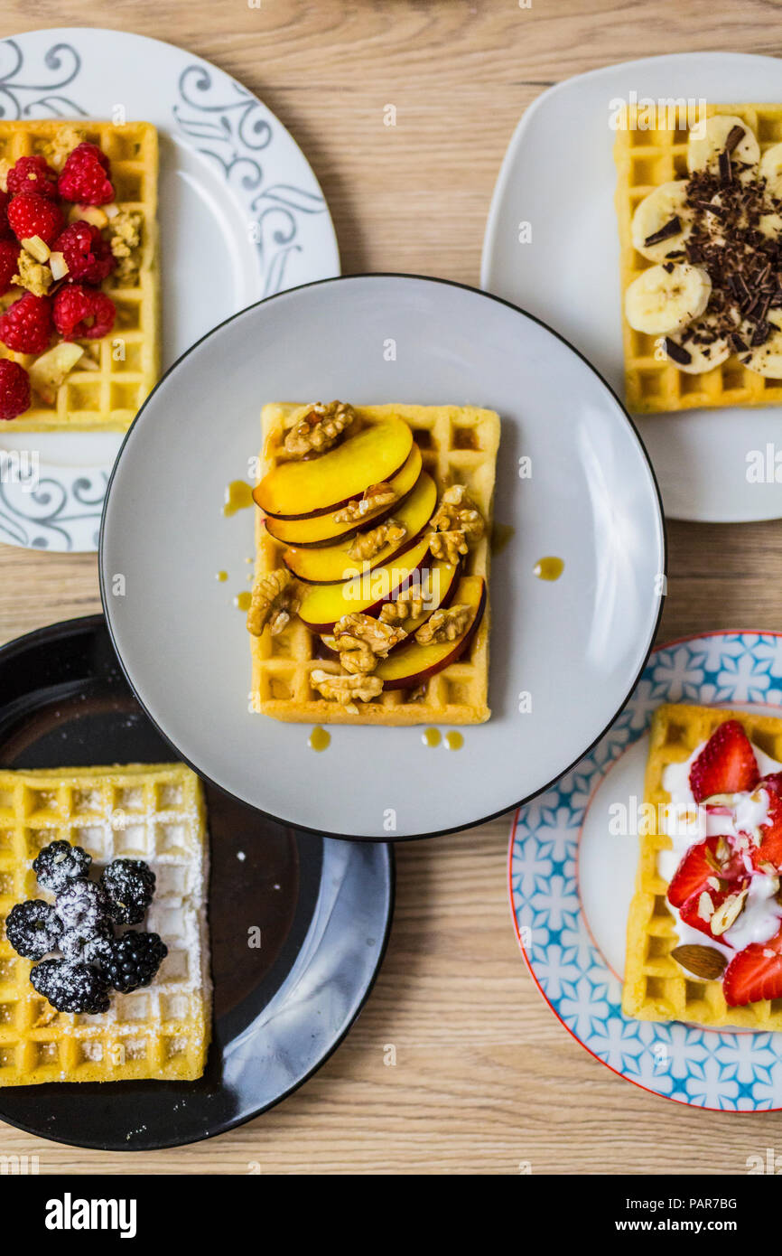 Plates of waffles with various toppings Stock Photo Alamy