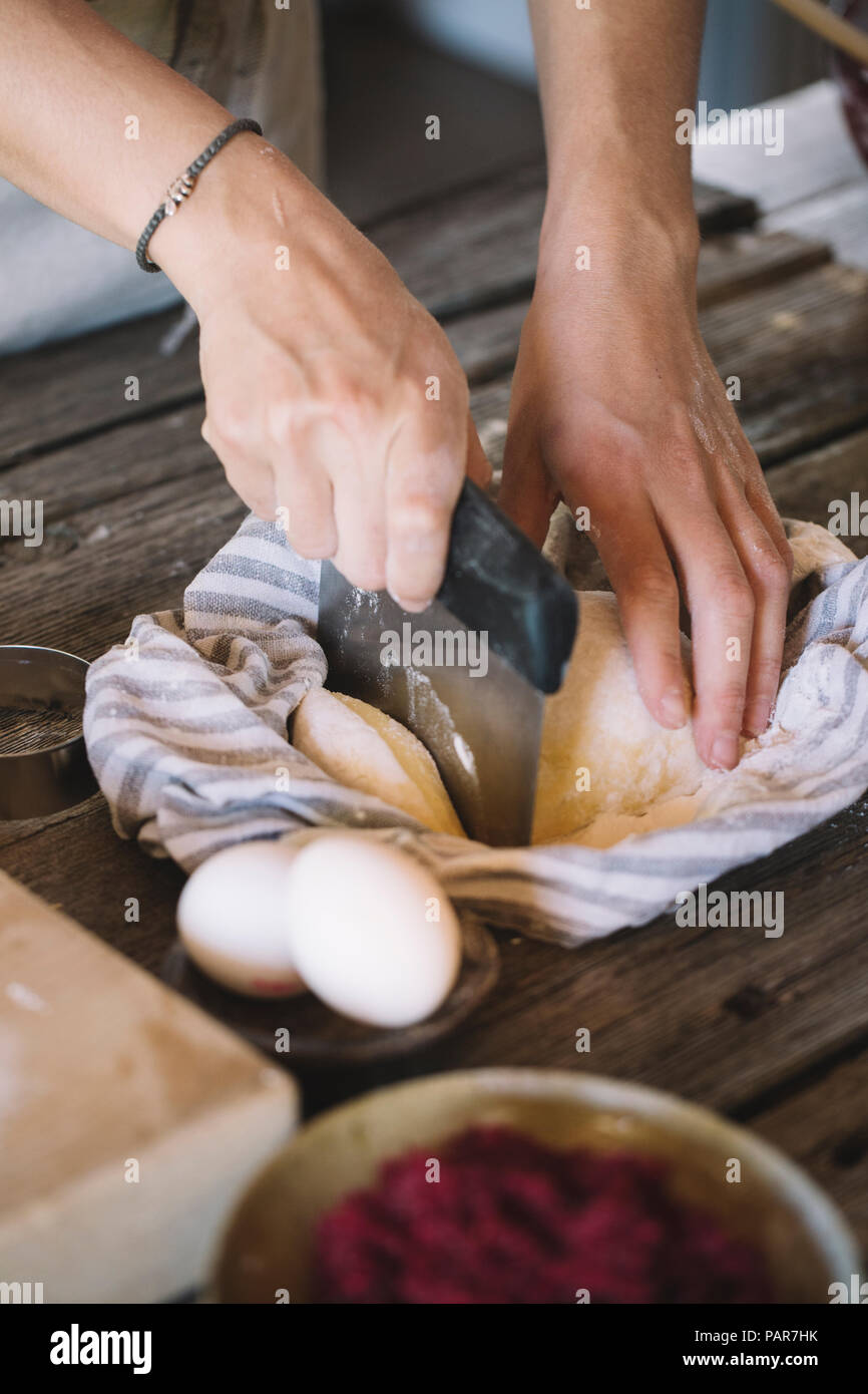 Raw pasta dough in kitchen towel, dough scraper Stock Photo