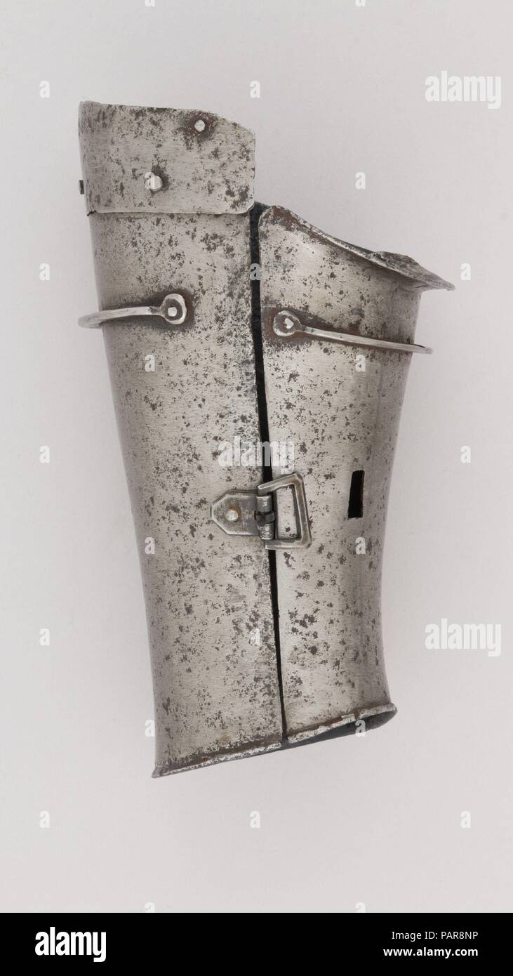 Defense for the Lower Left Forearm (Vambrace). Culture: Italian. Dimensions: H. 8 1/8 in. (20.6 cm); W. 5 in. (12.7 cm); D. 4 1/4 in. (10.8 cm); Wt. 1 lb. 4.1 oz. (569.8 g). Date: ca. 1400-1425.  This piece is notable for the early presence of stop-ribs, the two curved struts riveted to the outer and inner plates. These were designed to stop the point of a weapon from sliding into a vulnerable joint or gap between the plates. Museum: Metropolitan Museum of Art, New York, USA. Stock Photo