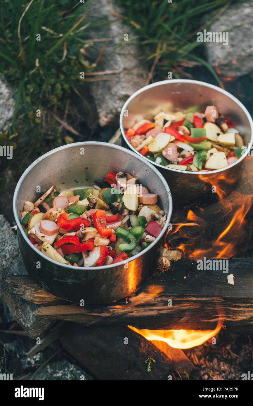 Norway, Lofoten, Moskenesoy, Food cooking on camp fire Stock Photo