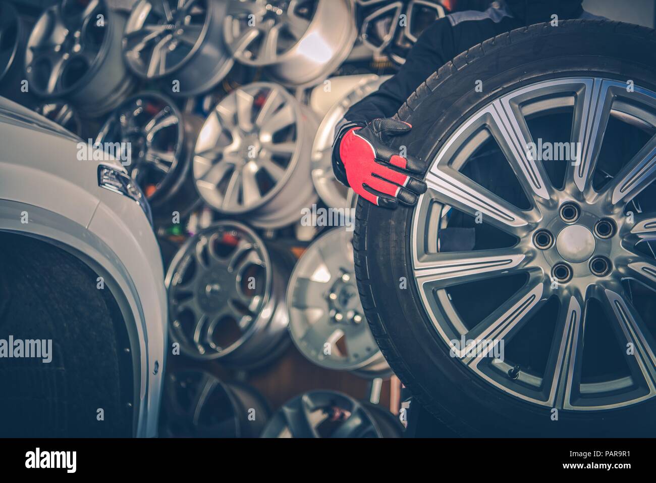 Picking New Alloy Wheels. Car Service Mechanic with Large Sport Utility