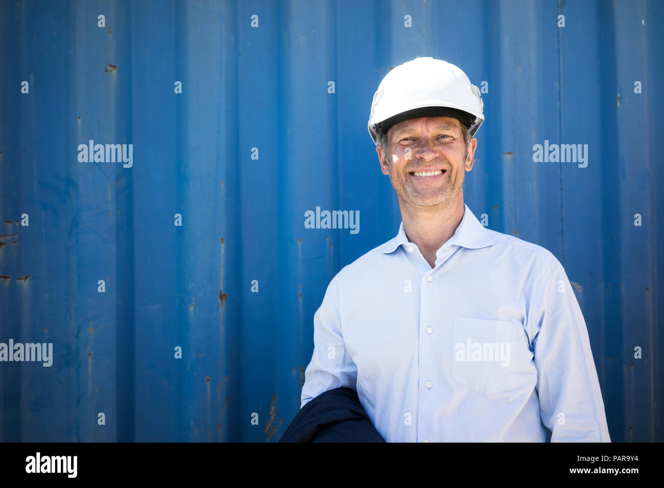 Portrait of smiling man wearing shirt and hard hat Stock Photo