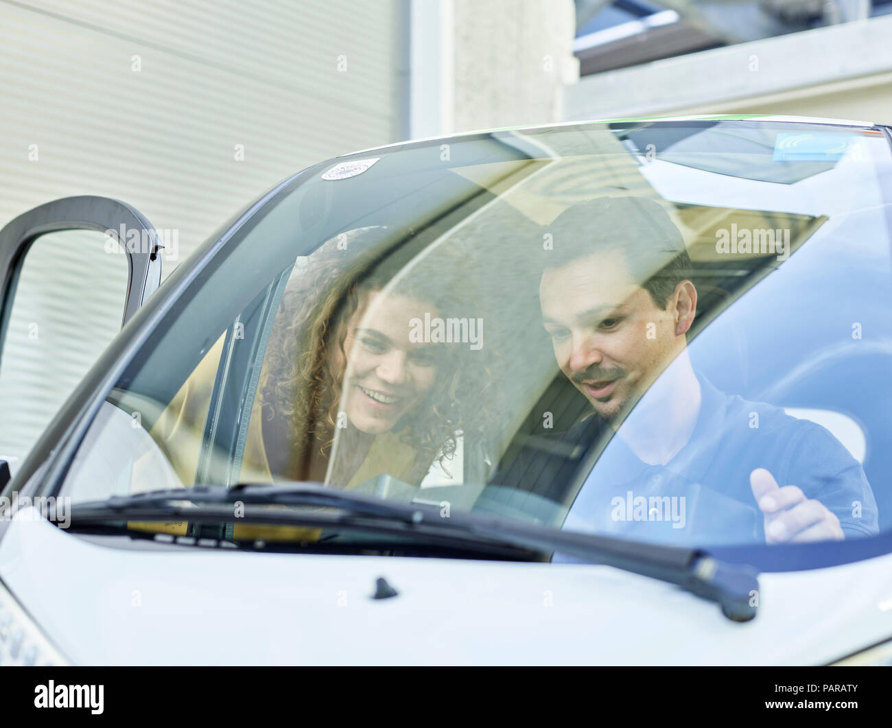 Smiling couple with electric bubble car Stock Photo