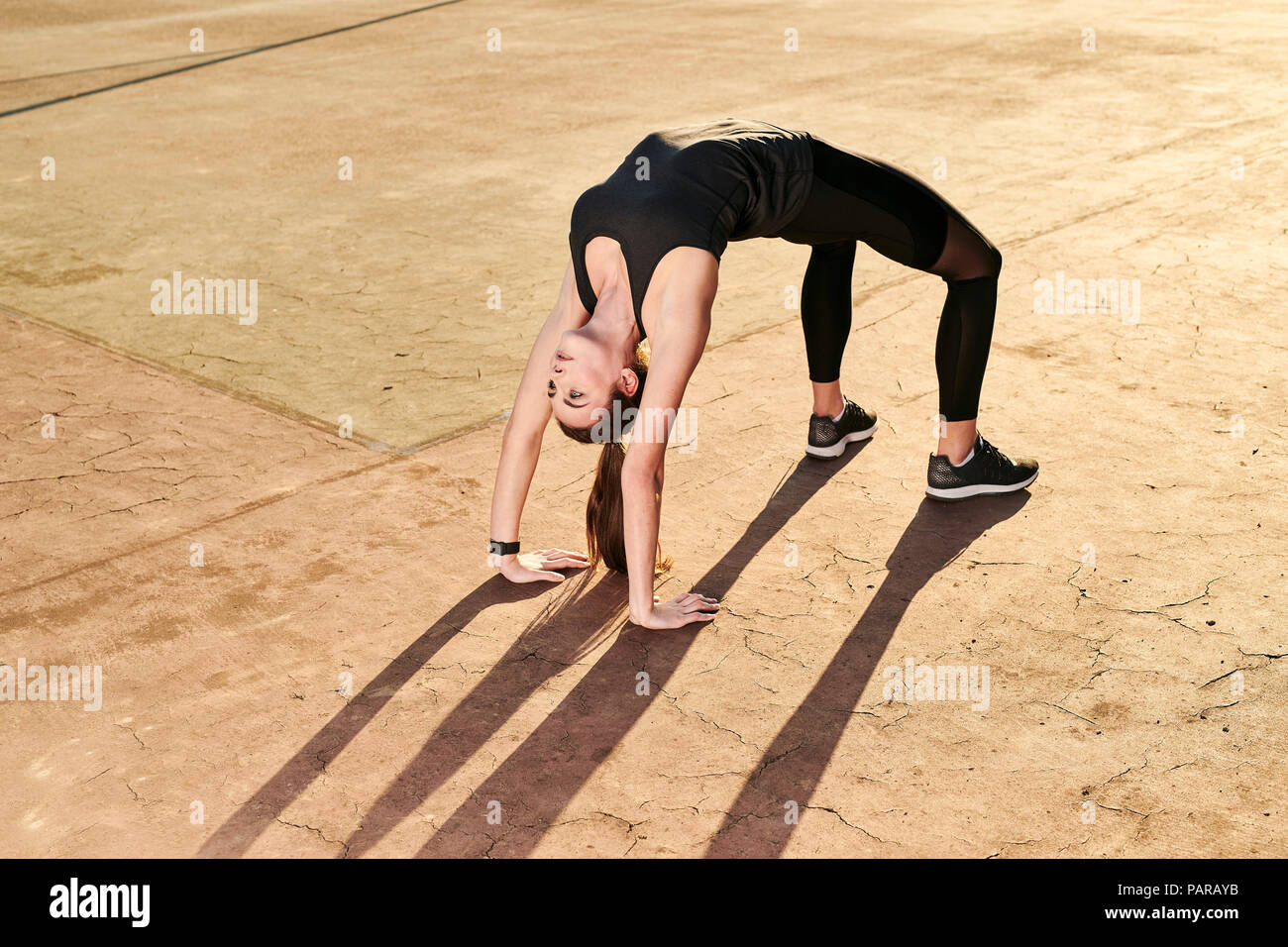 Sportive woman doing yoga, bridge position Stock Photo