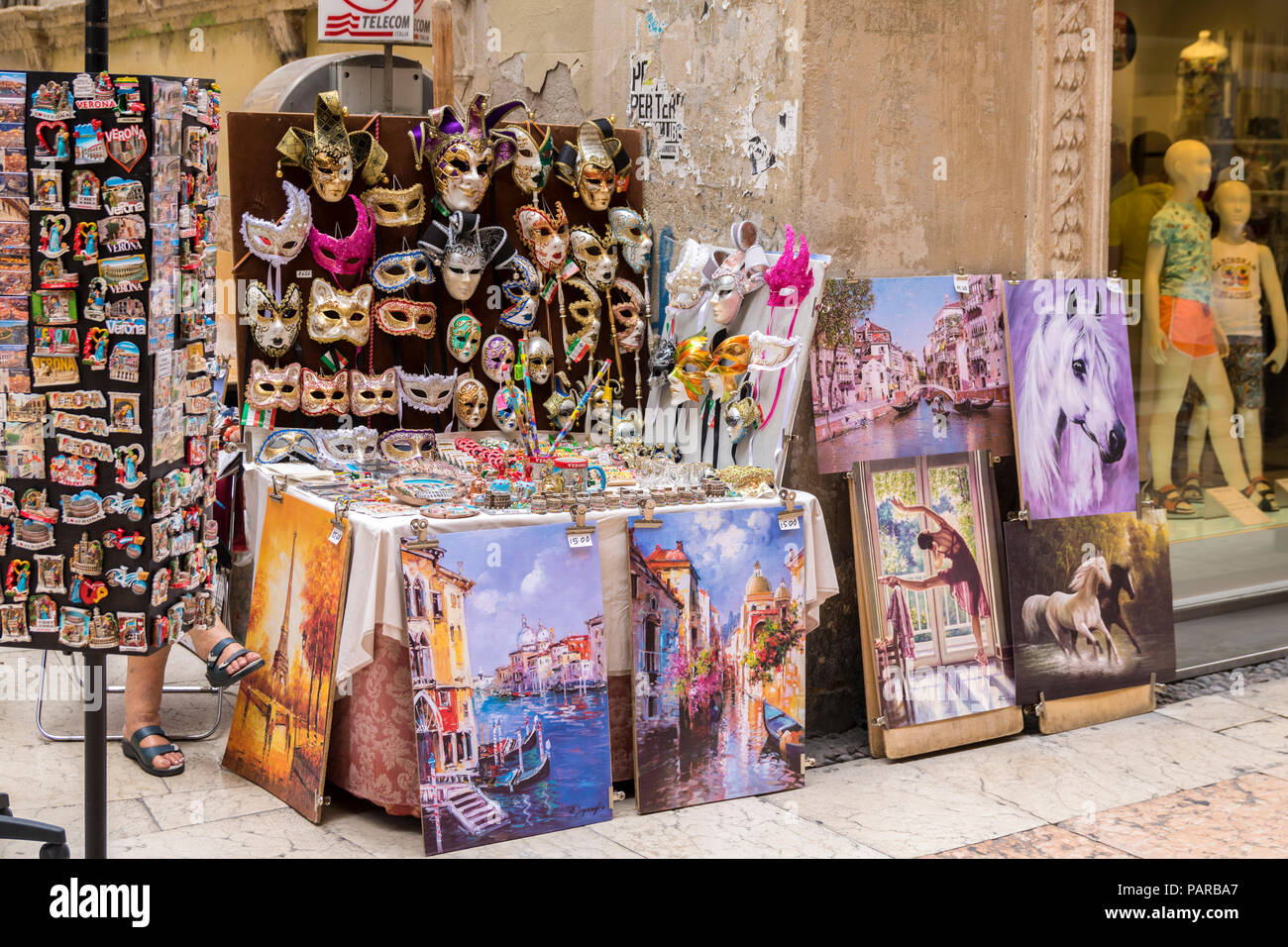 Art stall on a street in Verona italy, market stall, masquerade carnival masks, italiian street stall, vender, oil paintings, artwork on sale Stock Photo