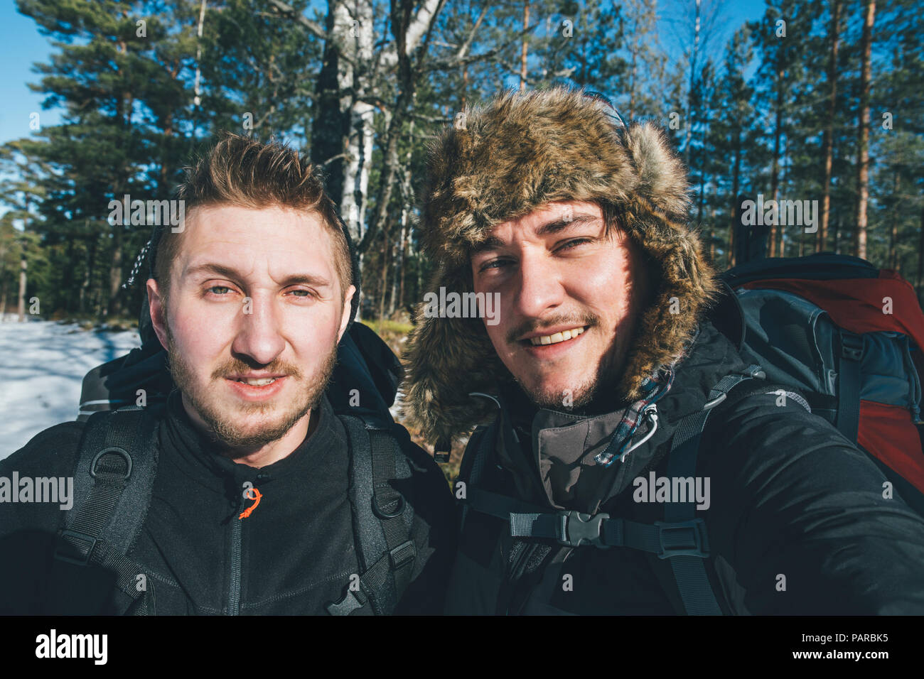 Sweden, Sodermanland, portrait of two smiling men in remote landscape in winter Stock Photo