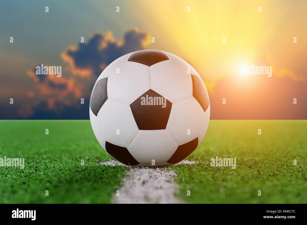 soccer ball on soccer field at sunset. Stock Photo