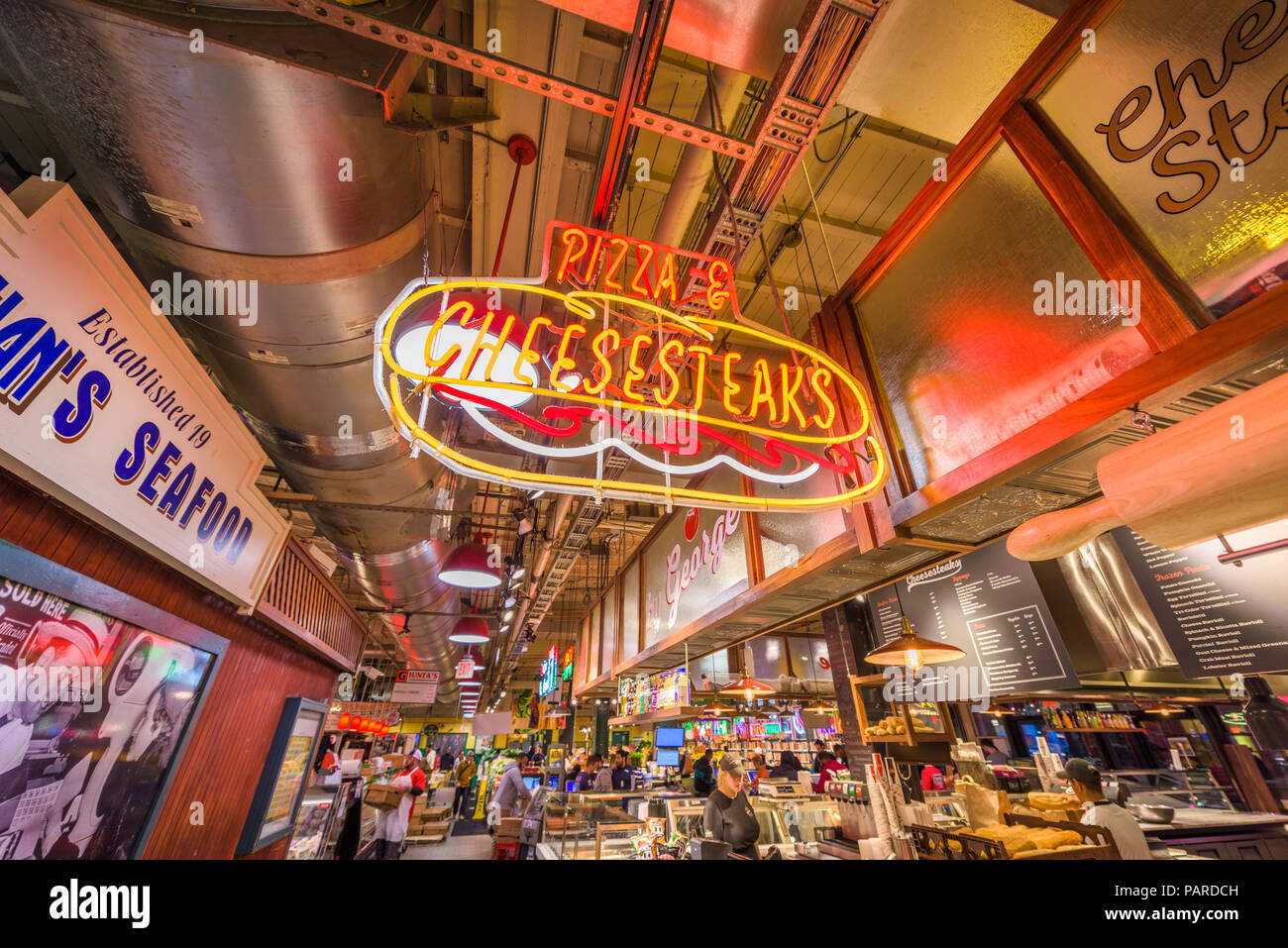 PHILADELPHIA, PENNSYLVANIA - NOVEMBER 18, 2016: Vendors and customers in Reading Terminal Market. The historic market is a popular attraction for culi Stock Photo