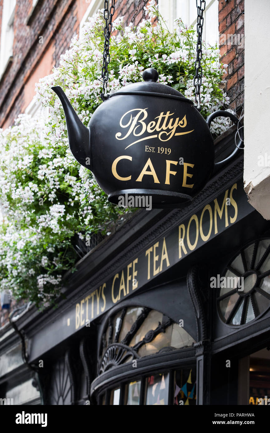 The facade of The Little Betty’s Cafe and Tea Rooms in York, UK showing the large teapot sign that hangs from the front of the store. Stock Photo