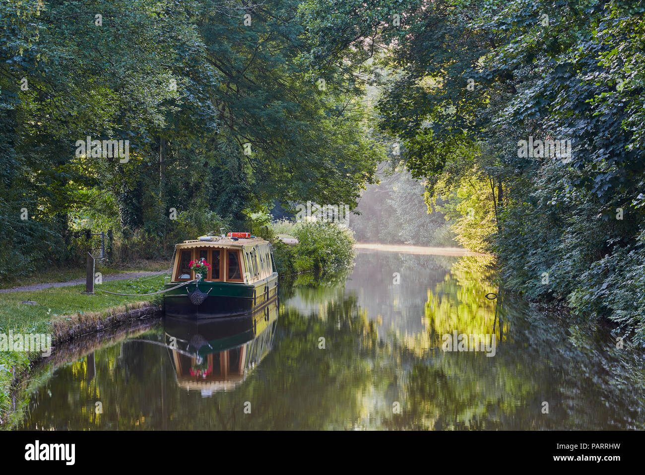 A barge moored against the bank of the Monmouthshire and Brecon canal in early summer near Llangynidr, Powys, Mid Wales, UK Stock Photo