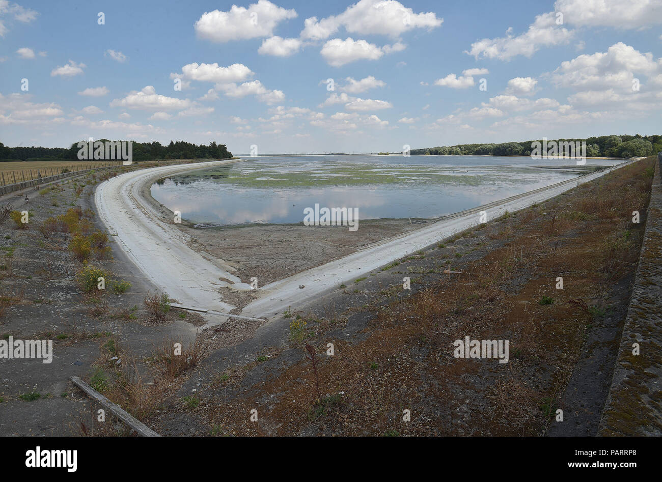 Very low water levels, which normally sits on the weeded banks, at Hanningfield reservoir, near Chelmsford in Essex, as the hot weather continues across the country. Stock Photo