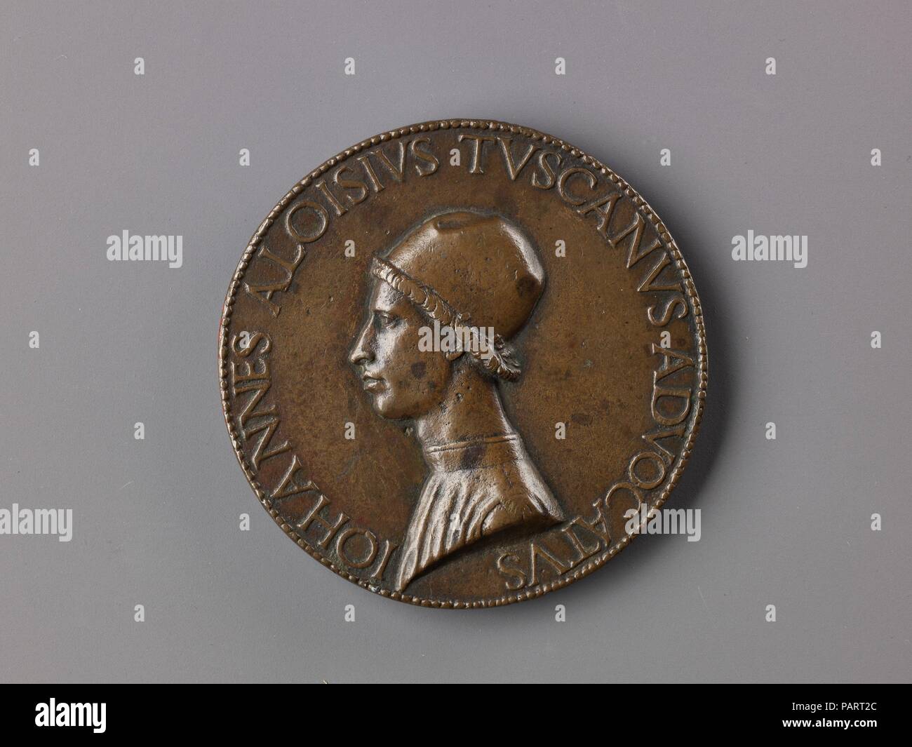 Portrait medal of Giovanni Alvise Toscani. Artist: Lysippus the Younger (Italian, active Rome, ca. 1470-84). Dimensions: Diam. 7.3 cm, wt. 107.3 g.. Date: ca. 1475 (possibly cast early 16th century).  Milanese by birth, Giovanni Alvise Toscani was a lawyer, orator, and Latin poet. He began his career under Francesco I Sforza, Duke of Milan, before going to Rome in 1468, where he became advocate to the assembly of cardinals and auditor under Pope Sixtus IV. Lysippus made six medals of Toscani, indicating their close friendship; this example is the largest and finest.  The reverse contains a lau Stock Photo