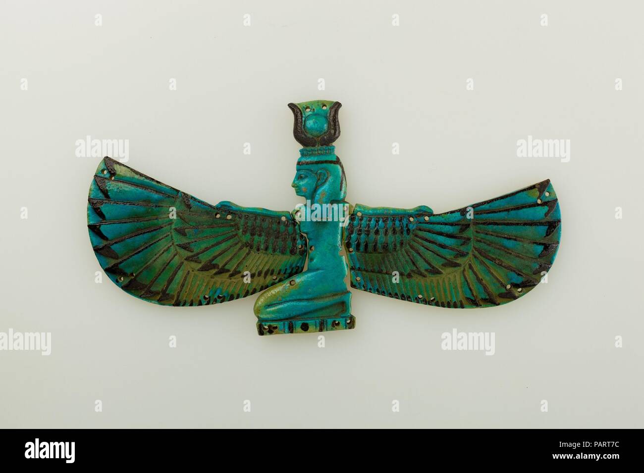 Winged Nut. Dimensions: H. 11.5 x W. 23.6 cm (4 1/2 x 9 5/16 in.). Dynasty: Dynasty 21-25. Date: ca. 1070-664 B.C..  The goddess of the sky, Nut, is represented here with her protective outspread wings. On her head are cows' horns and the sundisk, which are elements that could be worn by various goddesses. The small holes were made for sewing the pieces onto a mummy's wrappings, but such elements could also be incorporated into beaded nets, which were placed on top of a mummy's wrappings. Museum: Metropolitan Museum of Art, New York, USA. Stock Photo