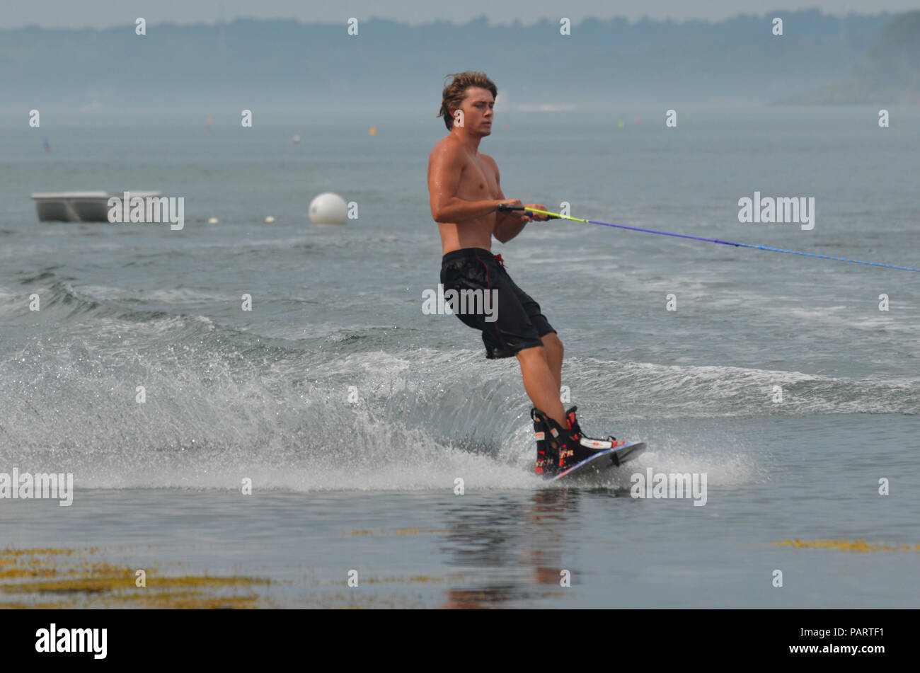 Wakeboarder creating a signficant spray on a wakeboard Stock Photo Alamy