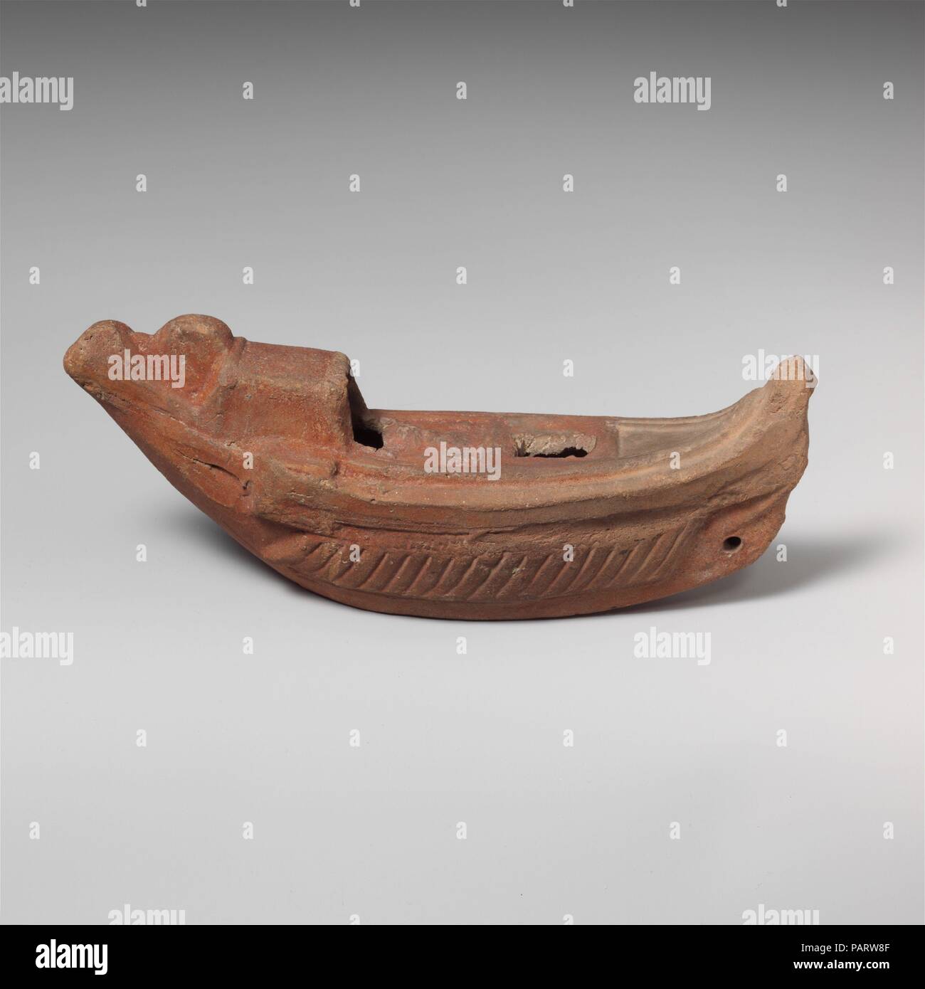 Terracotta oil lamp in the shape of a boat. Culture: Roman, Egyptian. Dimensions: length  6 1/4in. (15.9cm). Date: 2nd century A.D..  Lamp in the form of a boat. Museum: Metropolitan Museum of Art, New York, USA. Stock Photo