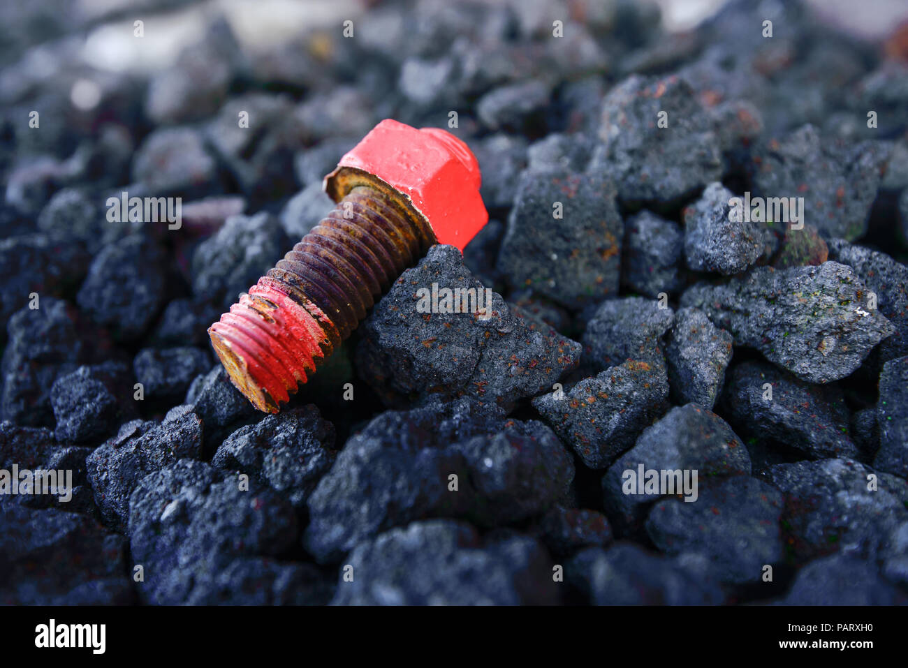 Old rusty red screw laying on black coal Stock Photo - Alamy