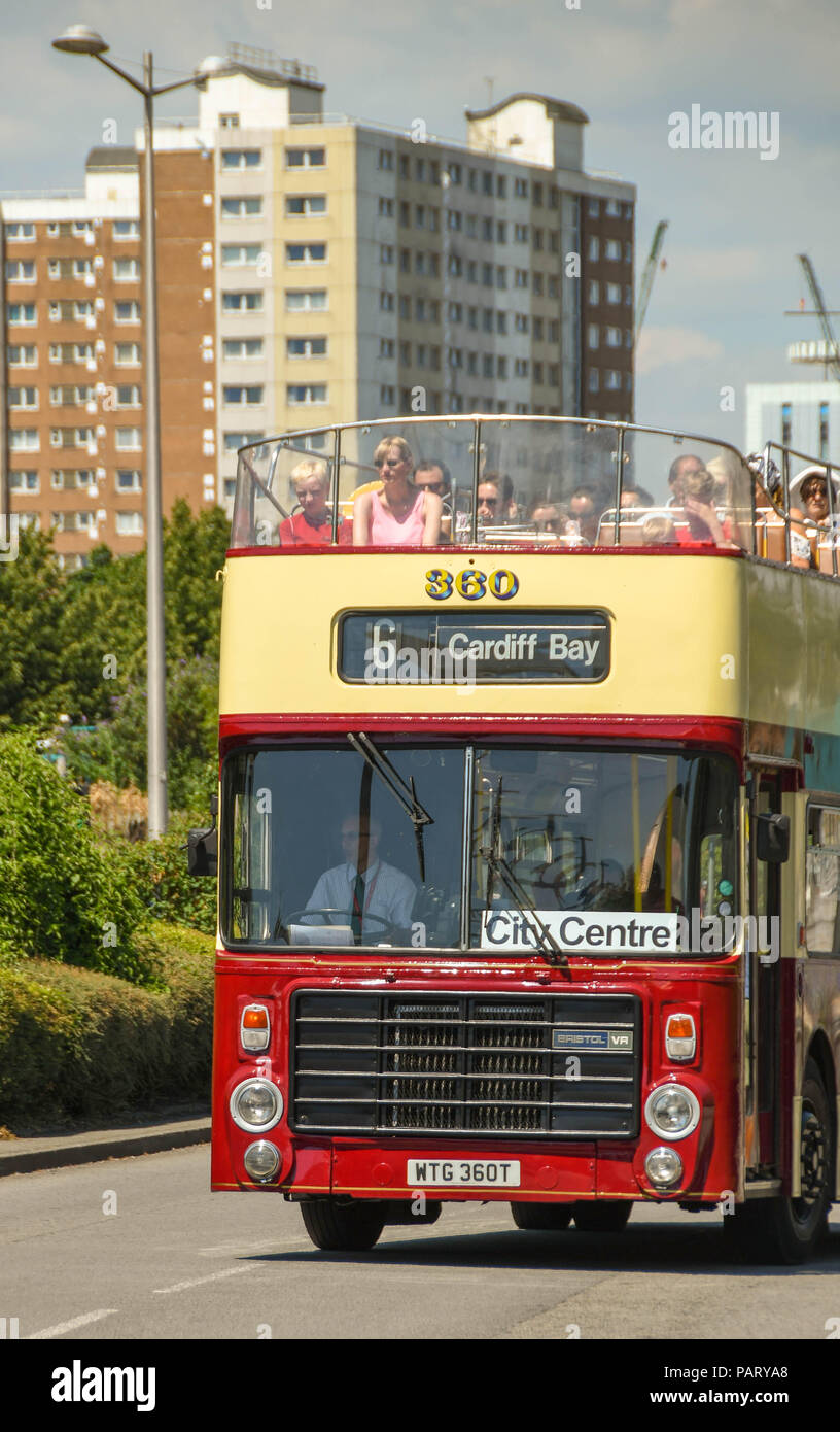 Head on view of an open top bus in Cardiff bay with visitors sitting on the top deck Stock Photo