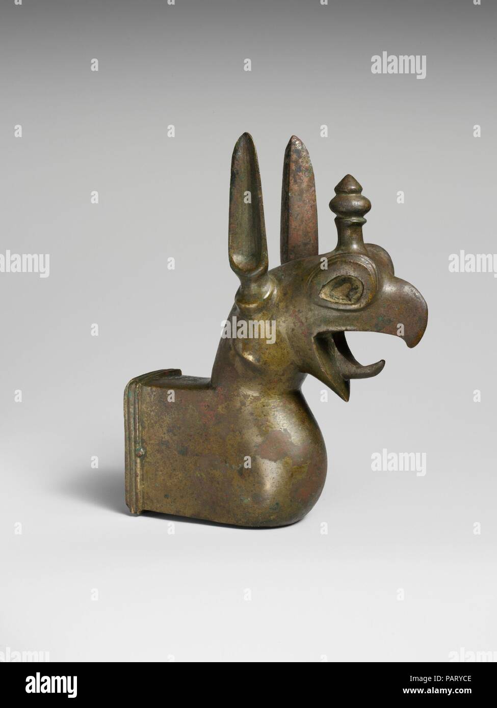 Bronze griffin attachment. Culture: Etruscan. Dimensions: H. 7 3/16 in. (18.2 cm). Date: ca. 600-575 B.C..  This heavy, solid-cast griffin was the finial for another object, perhaps an andiron. Originally, the eyes were inlaid with other materials, such as amber and ivory, to create a more lifelike realism. Museum: Metropolitan Museum of Art, New York, USA. Stock Photo